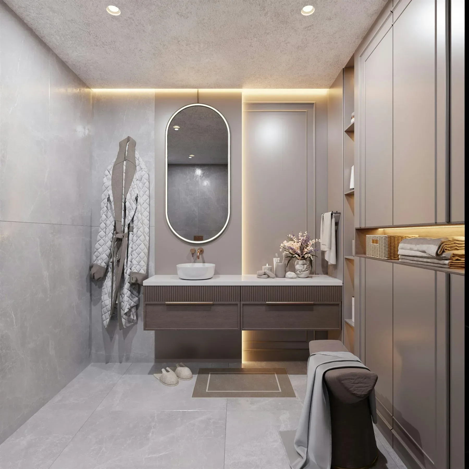Warm stone bathroom with soft lighting, rounded mirror, and muted neutral palette