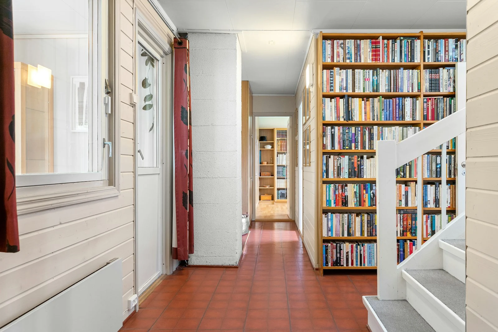 Long hallway with bookshelves