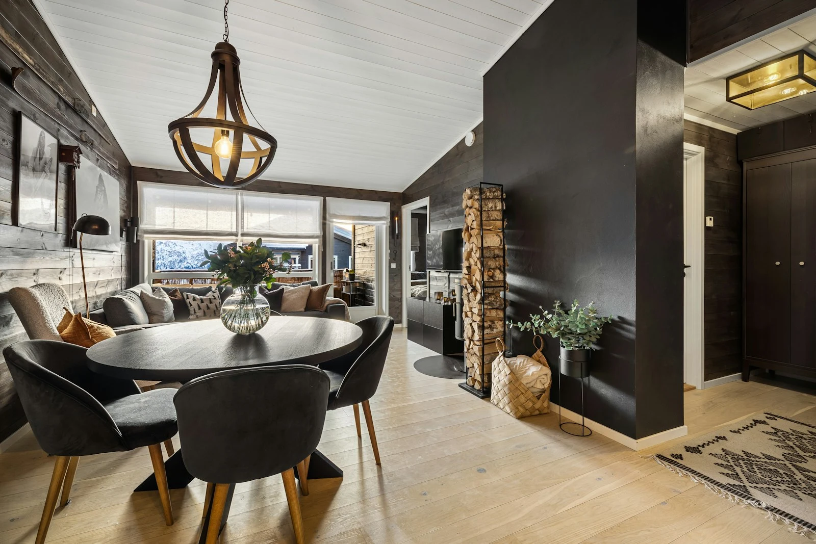 Round dining table and chairs on an exposed timber floor