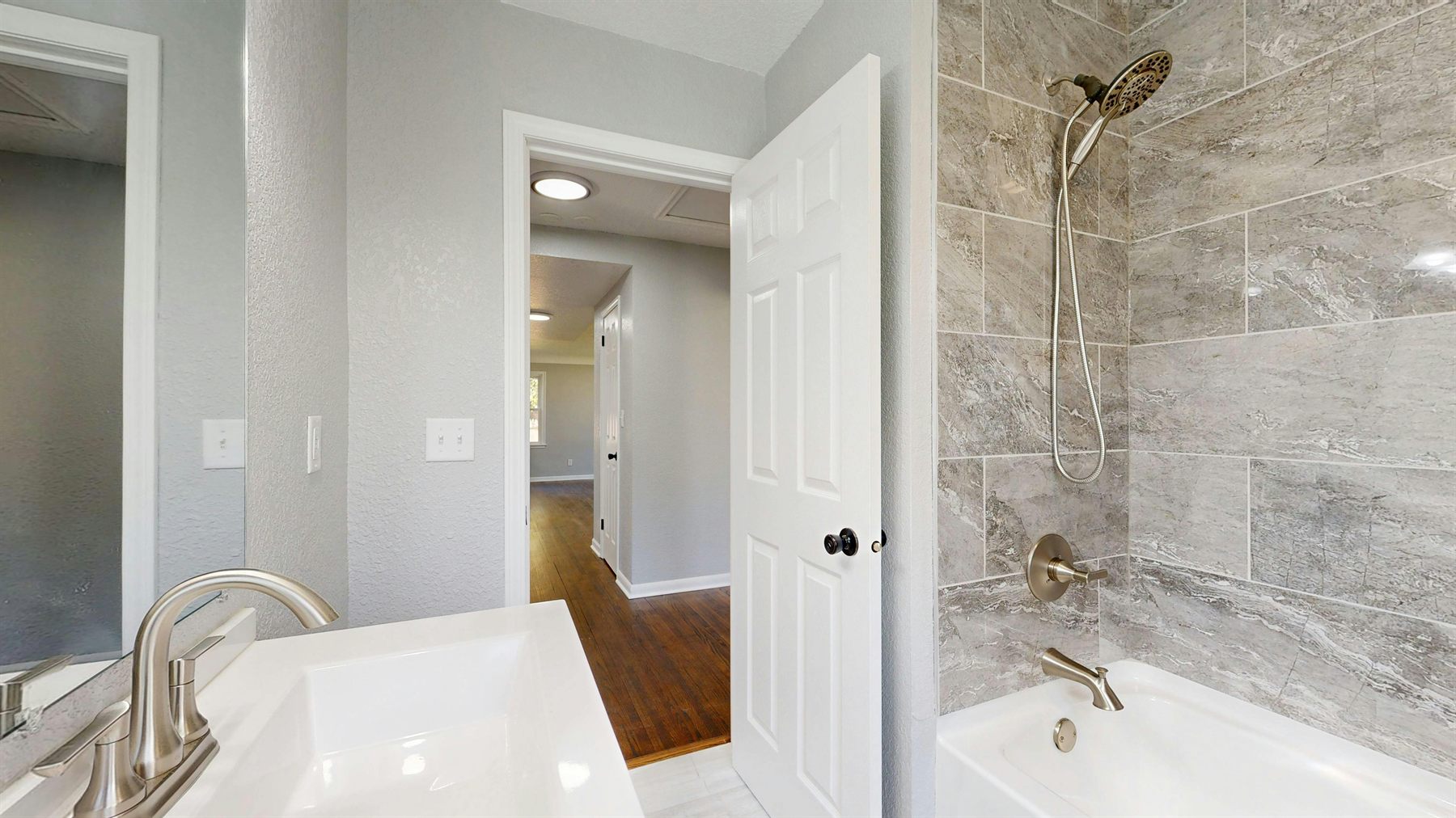 Light gray bathroom with shower wall tile and a fresh soft palette