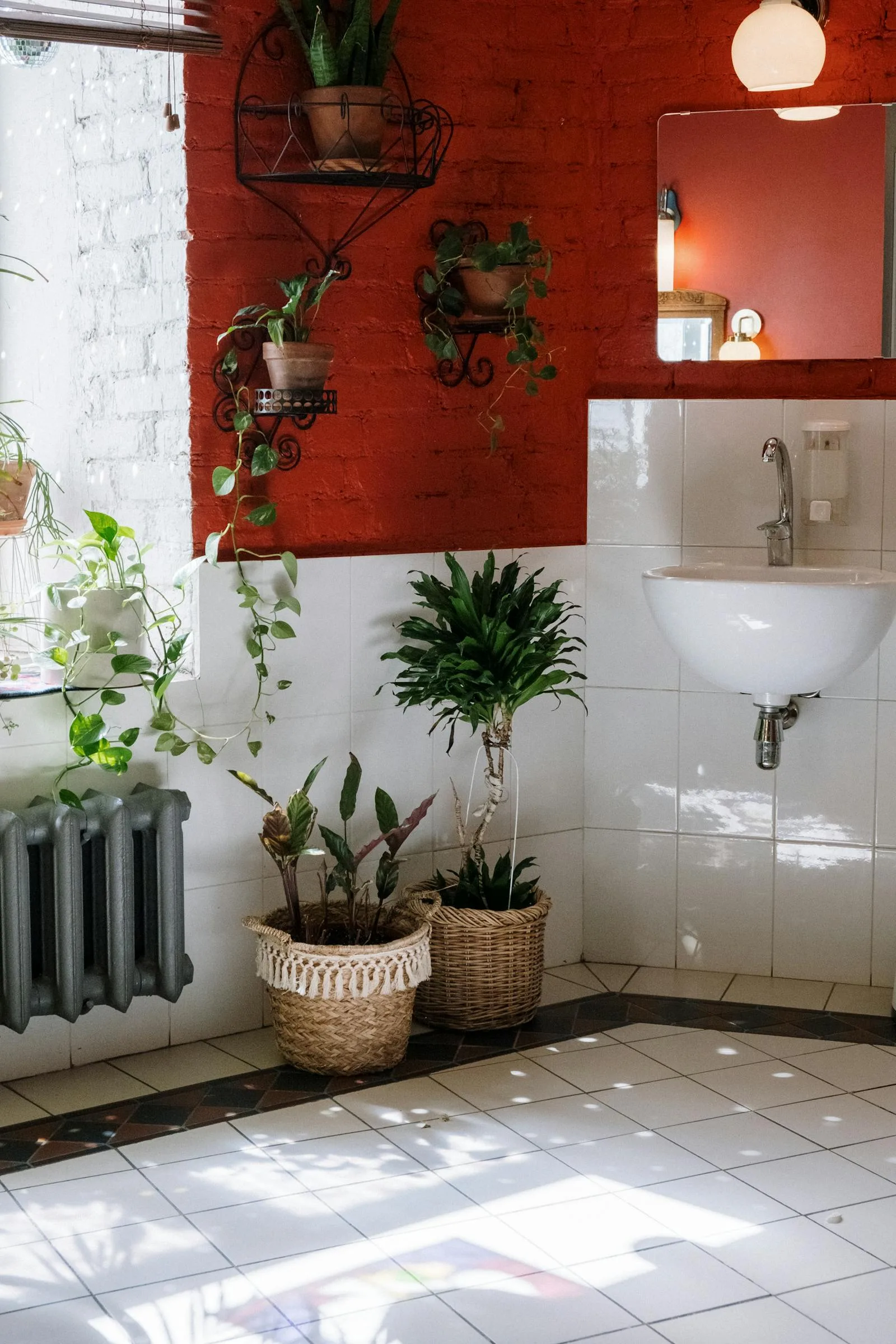 Bathroom floor corner with a few plants in woven baskets near natural light