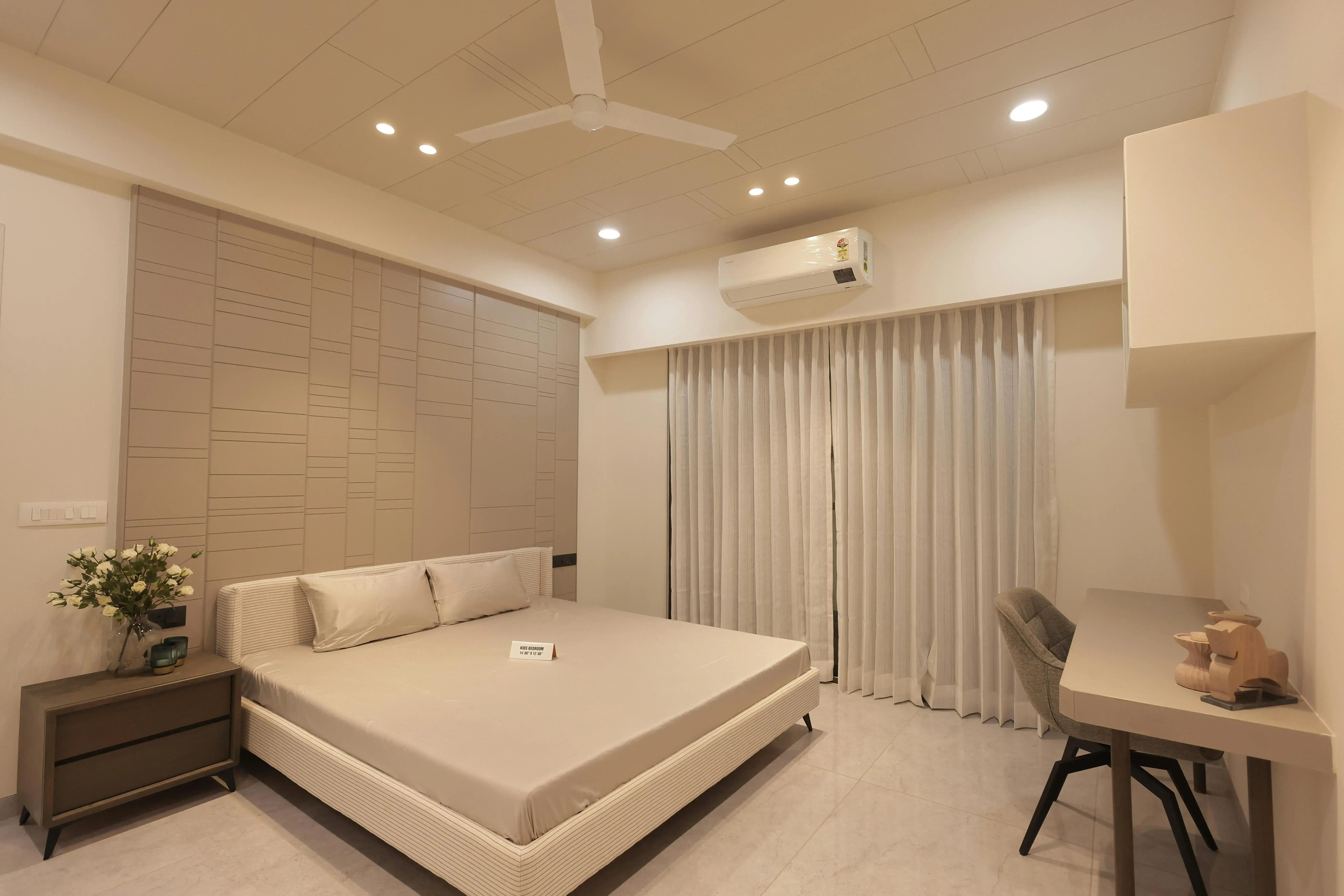 Bedroom where a desk and work zone compete visually with the bed
