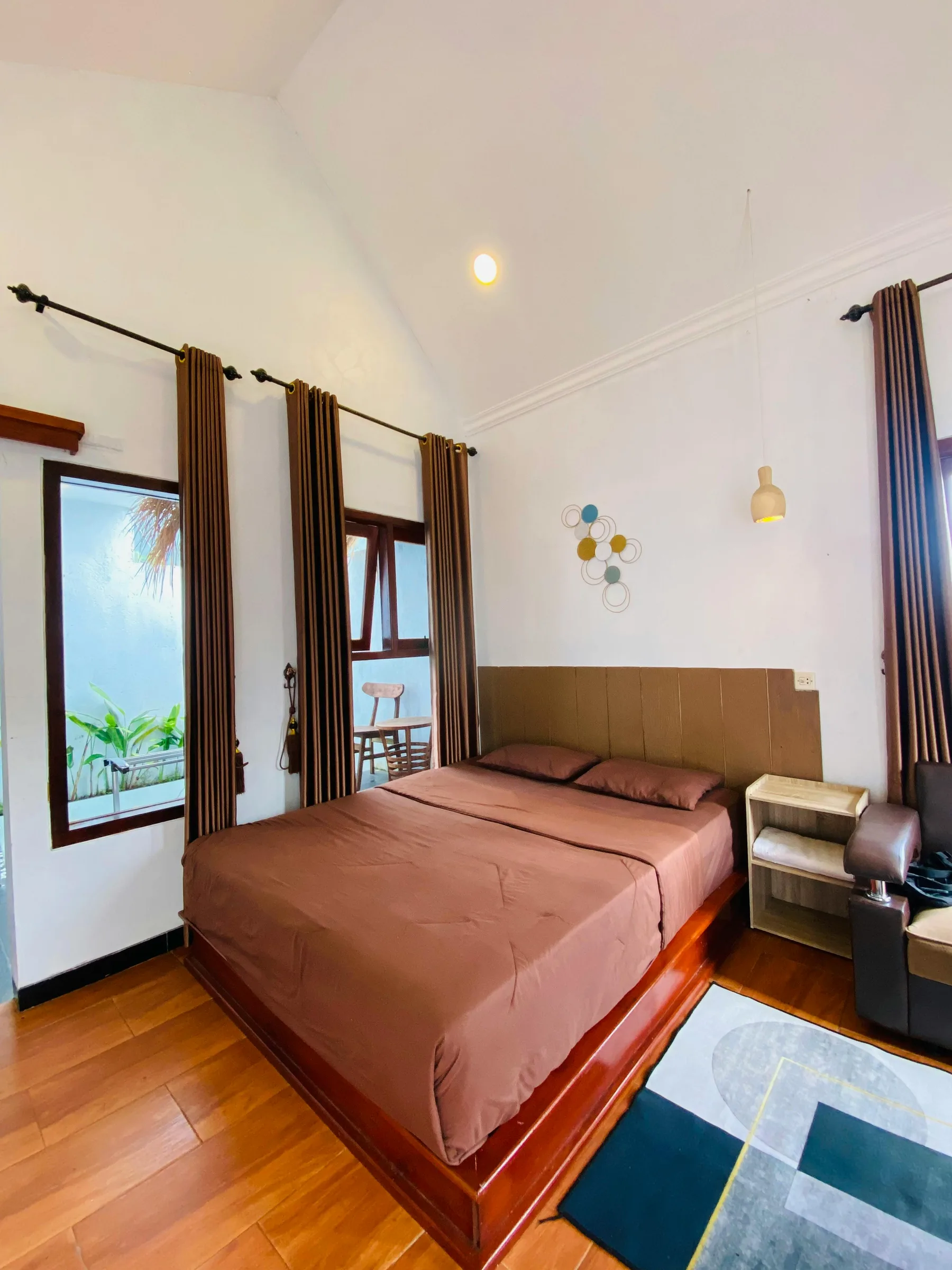 Warm brown bedroom with balanced nightstands, soft textures, and a stronger bed anchor