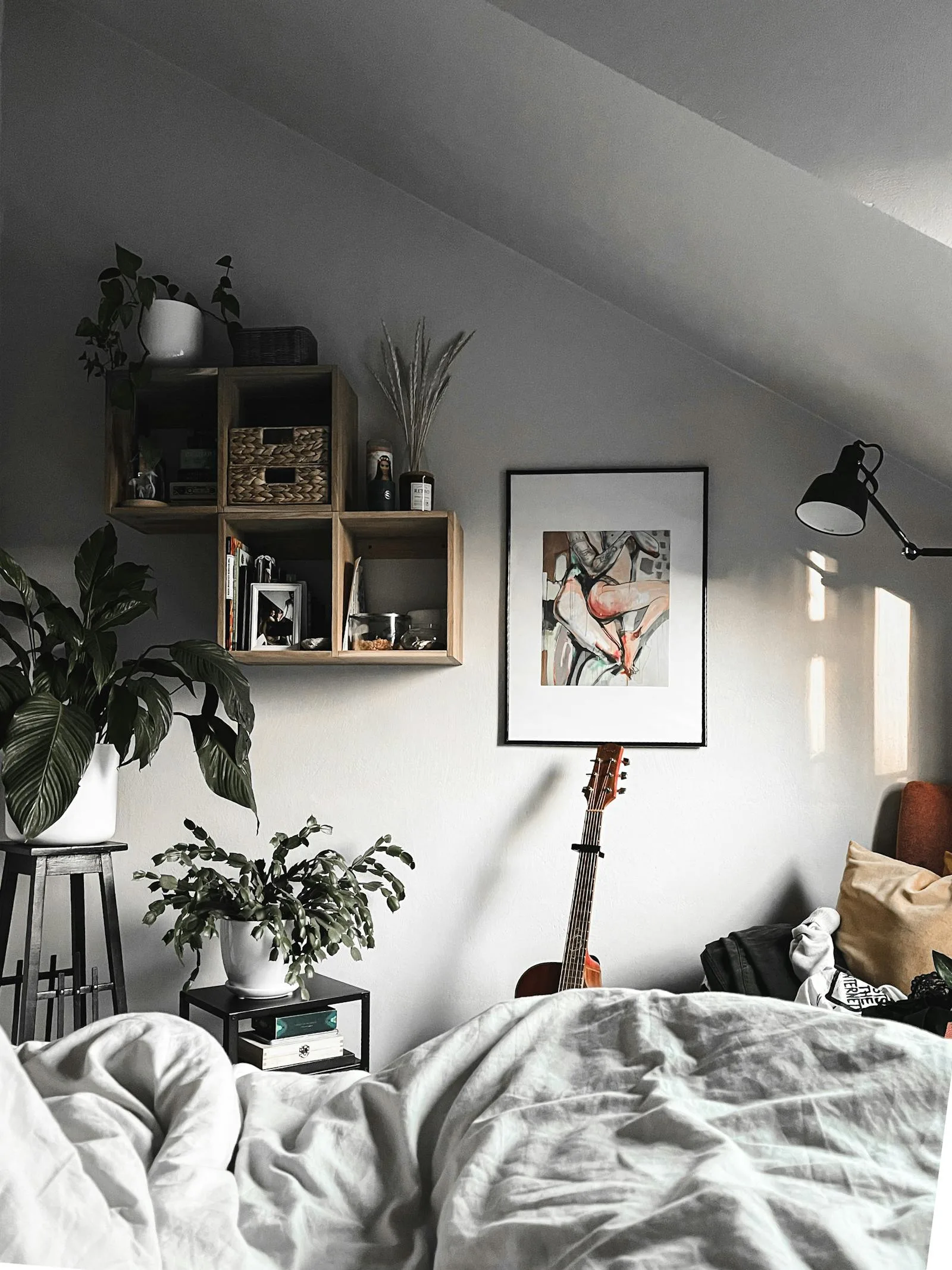 Cozy bedroom corner with leafy plant, soft chair, and gentle daylight