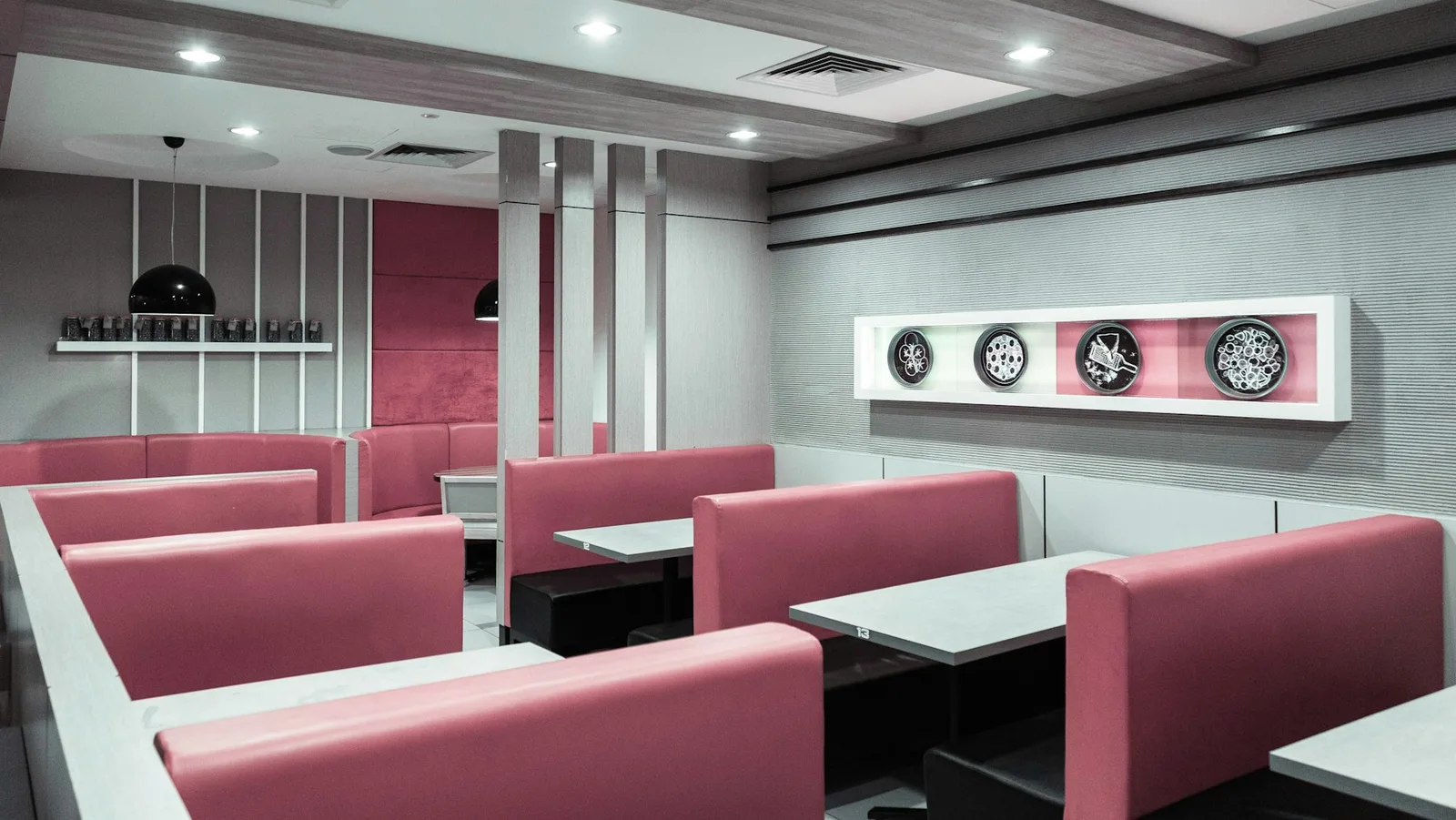 Red-heavy booth seating and wall color in a bright interior