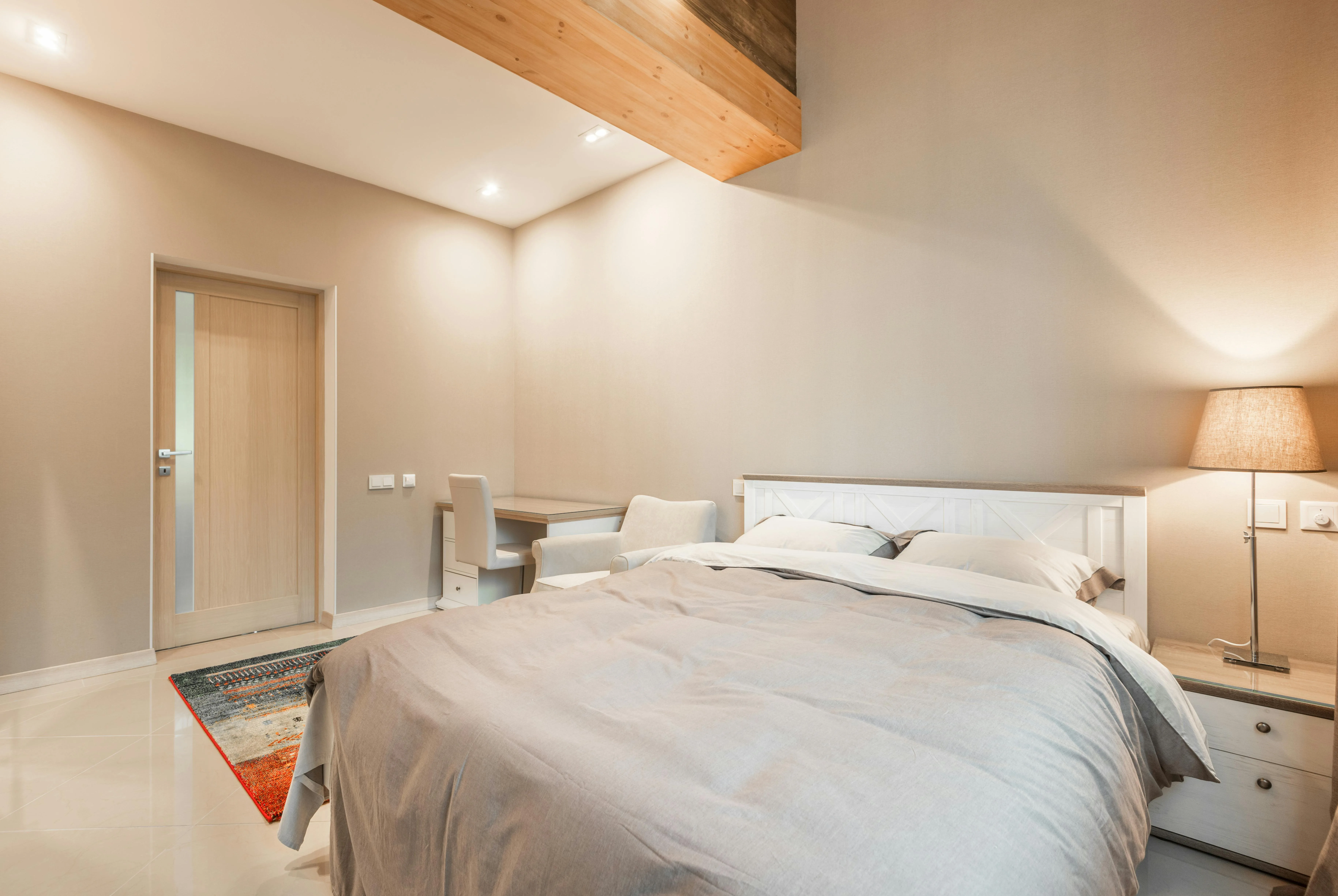 Bedroom with a desk tucked into the same room as the bed, making the space feel more mixed-use