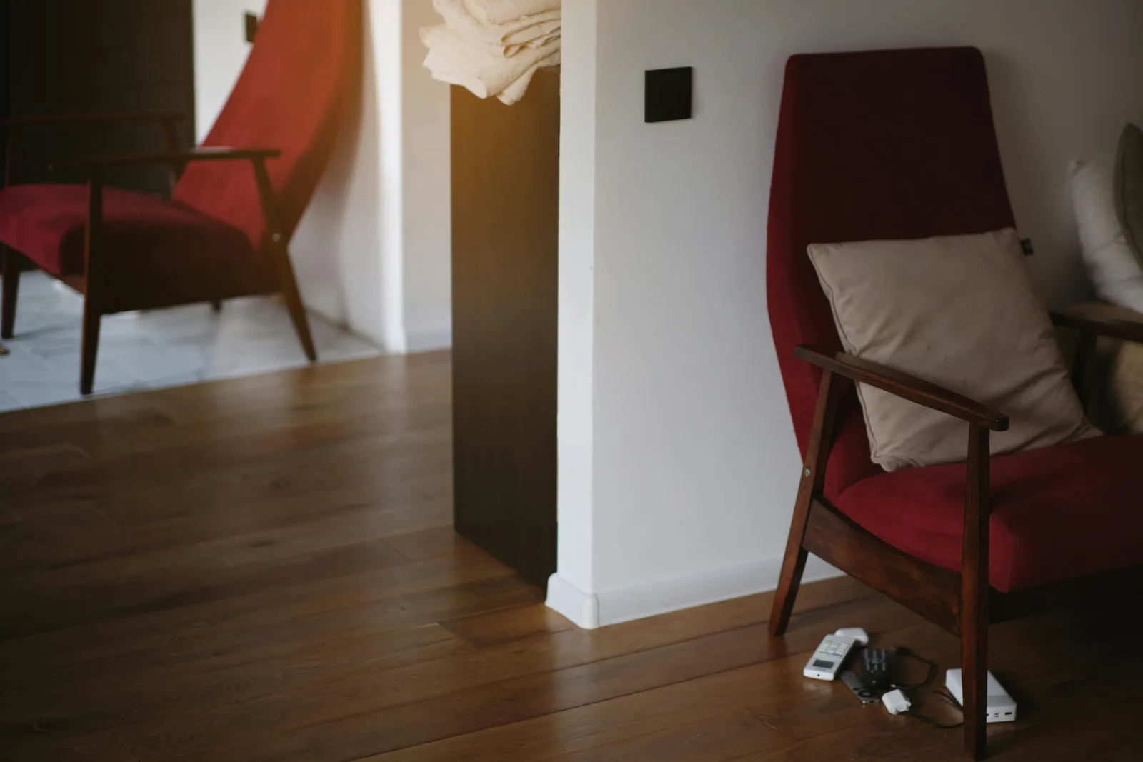 Deep red armchair in a room corner with a strong visual hit of color