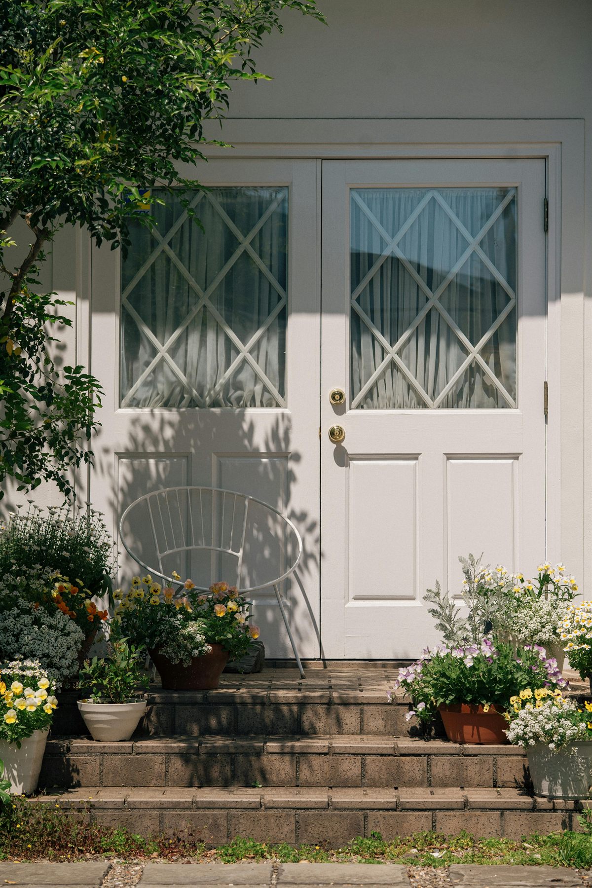 White front door with flowers on the steps