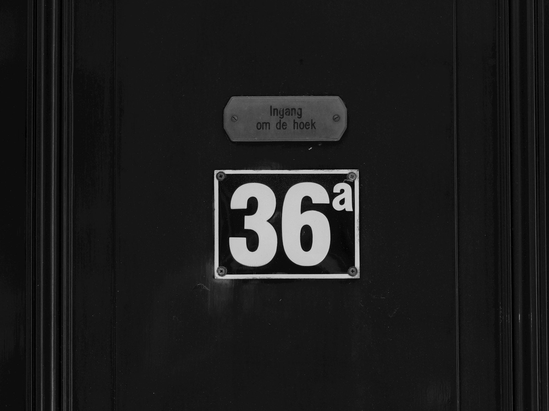 Black door with a bold easy-to-read house number