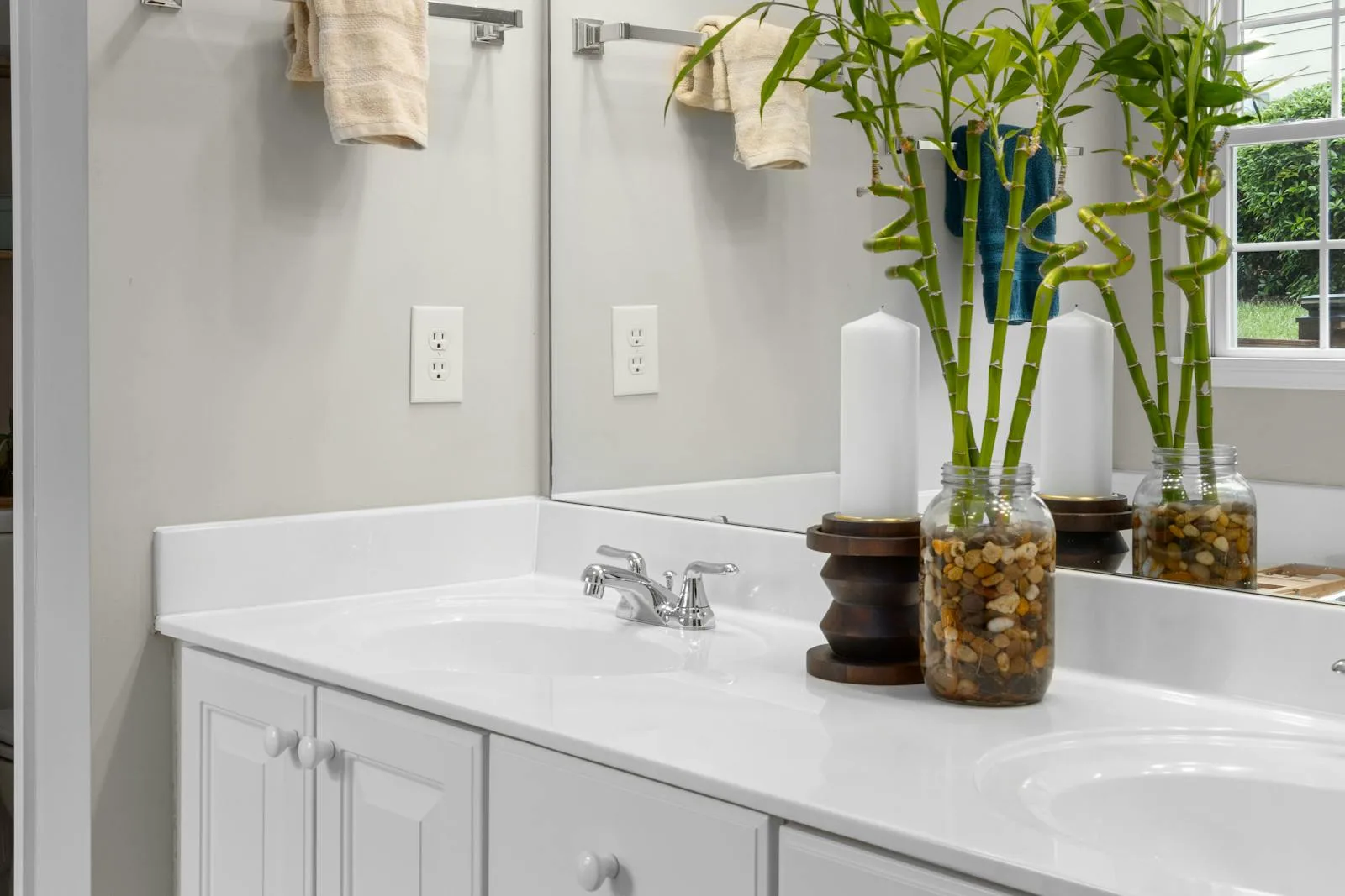 Bathroom vanity with bamboo stems and a soft gray-beige wall palette