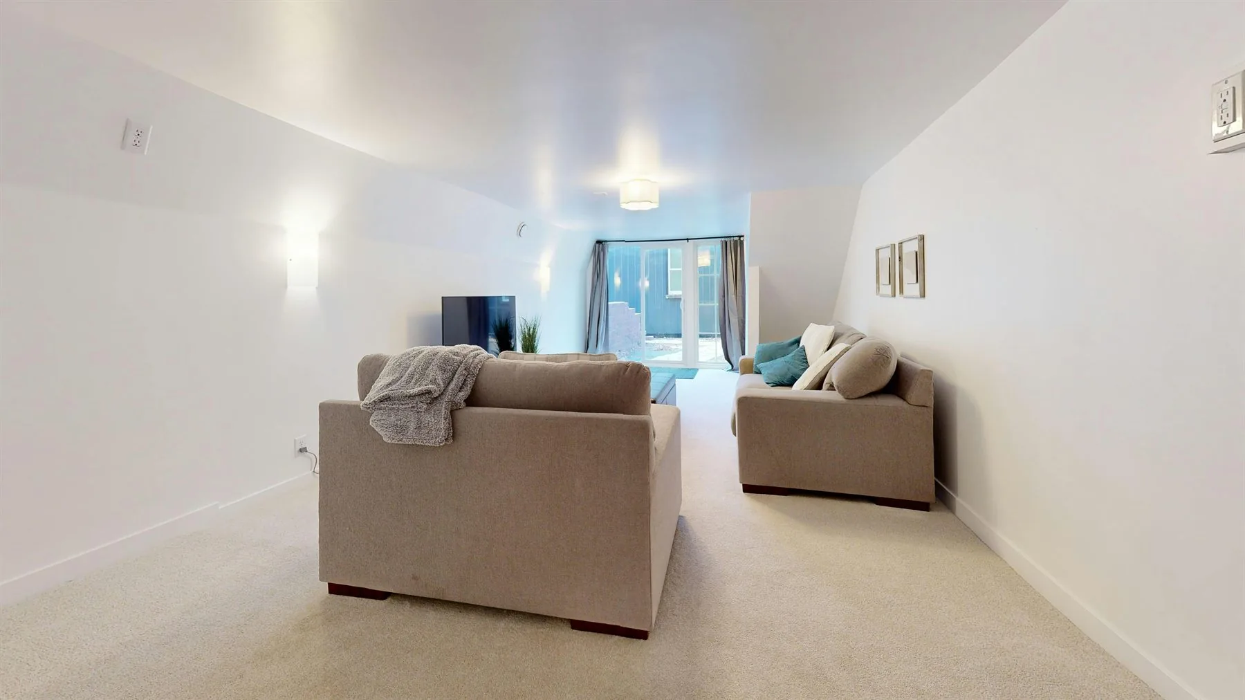 Warm connected home interior with calmer beige walls, natural wood, and soft layered textiles
