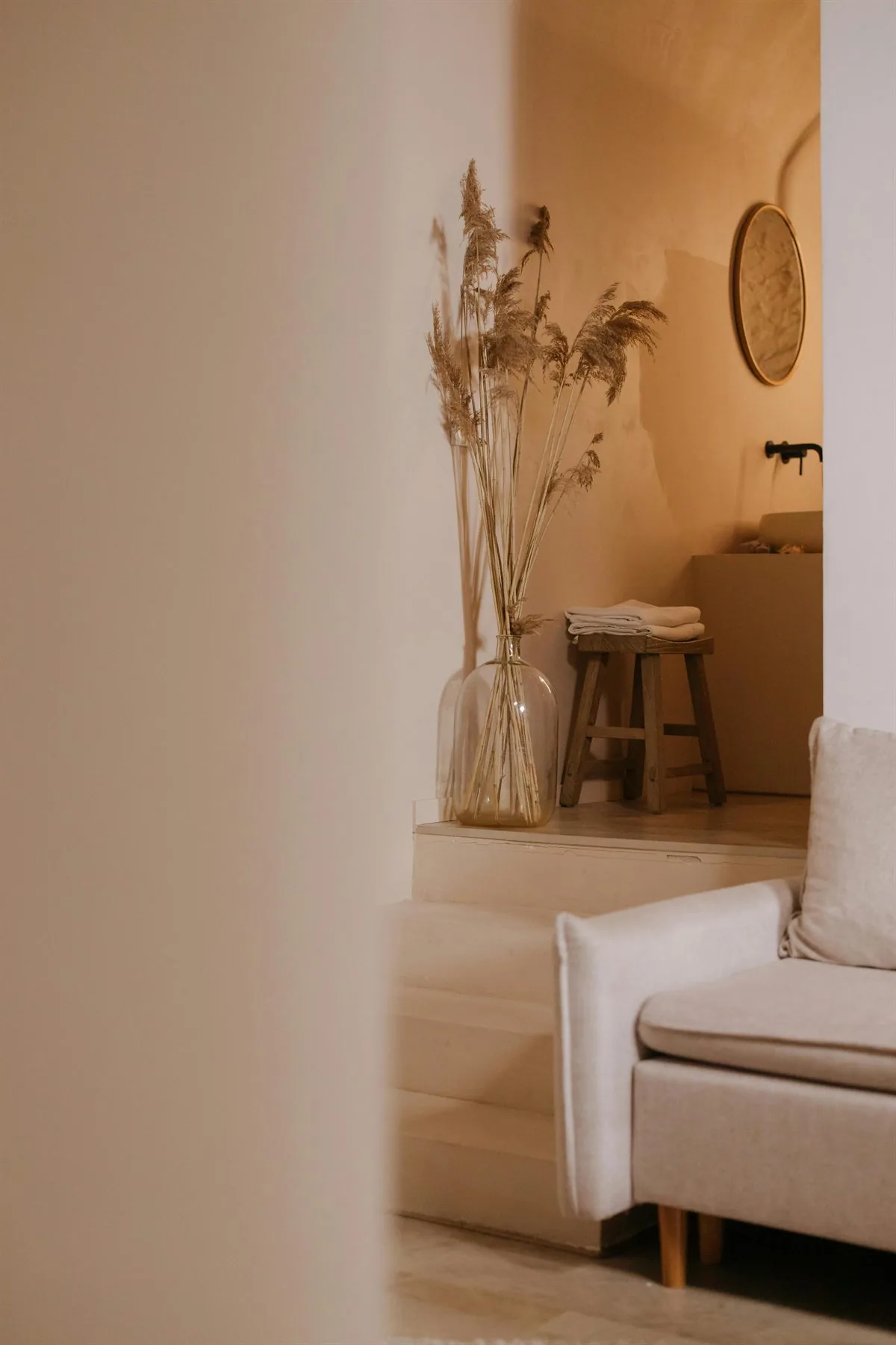 Warm home interior with layered neutral decor and soft natural light