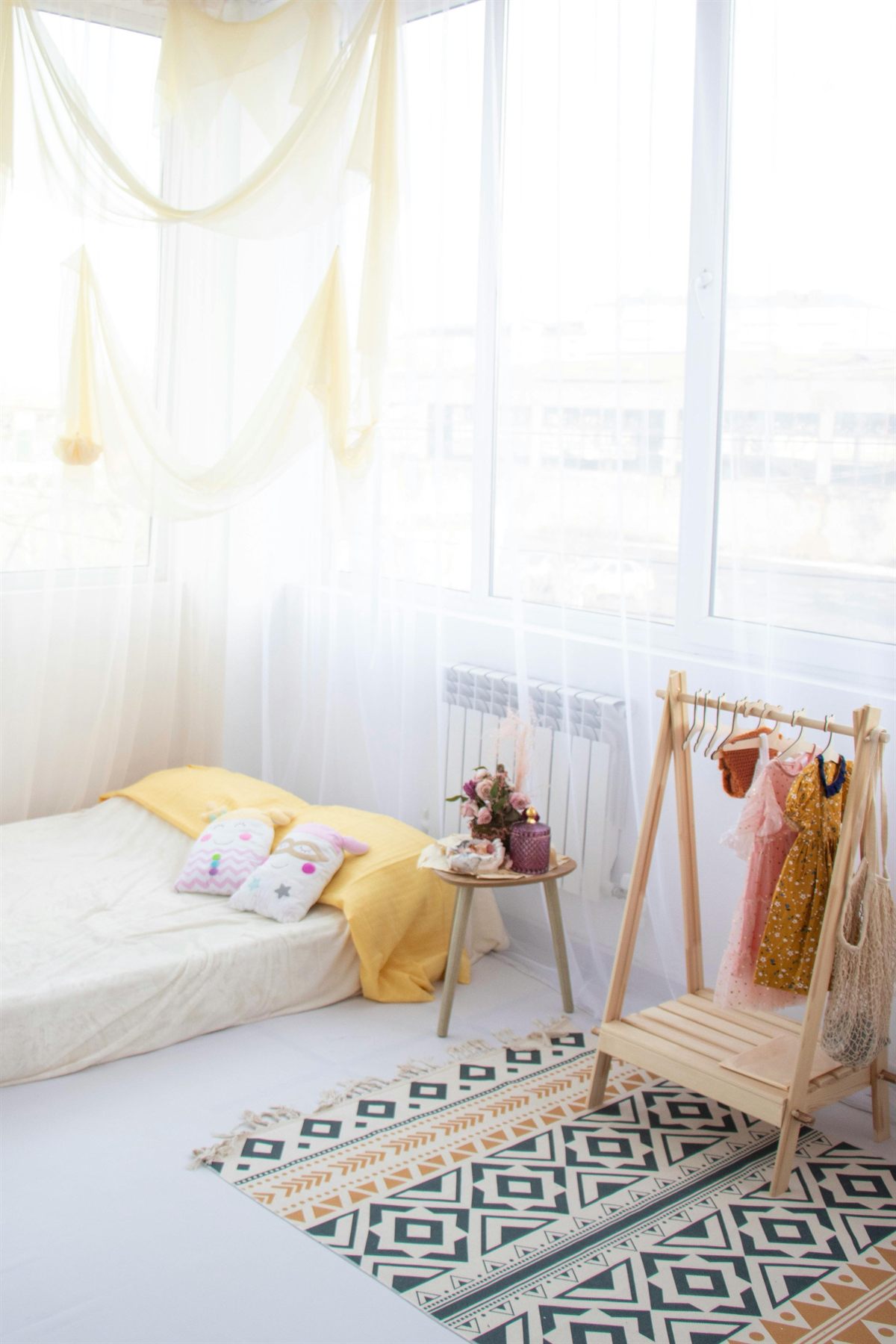 Softly styled kids bedroom with bed, light walls, and simple storage