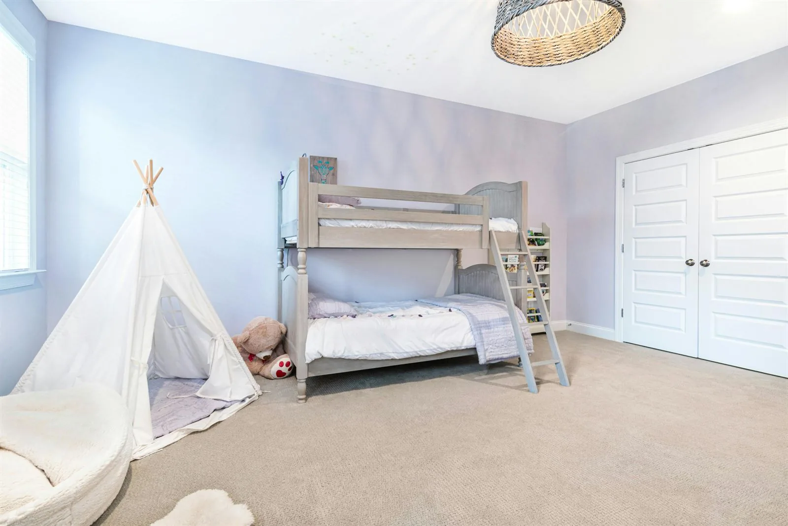 Kids room with lavender walls, bunk bed, soft rug, and a small teepee play tent