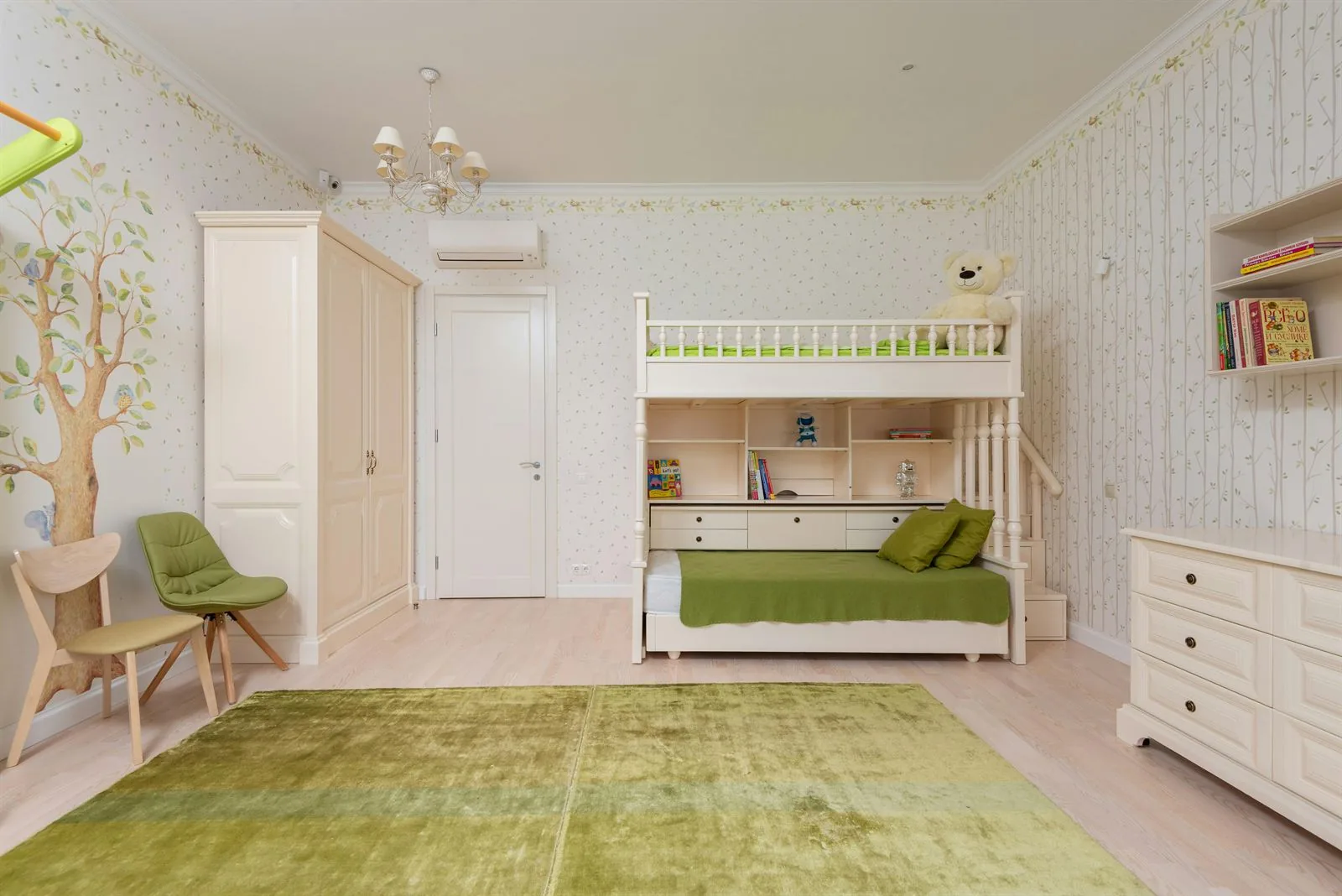 Kids bedroom with green bunk bed, built-in desk, soft wallpaper, and clear floor space
