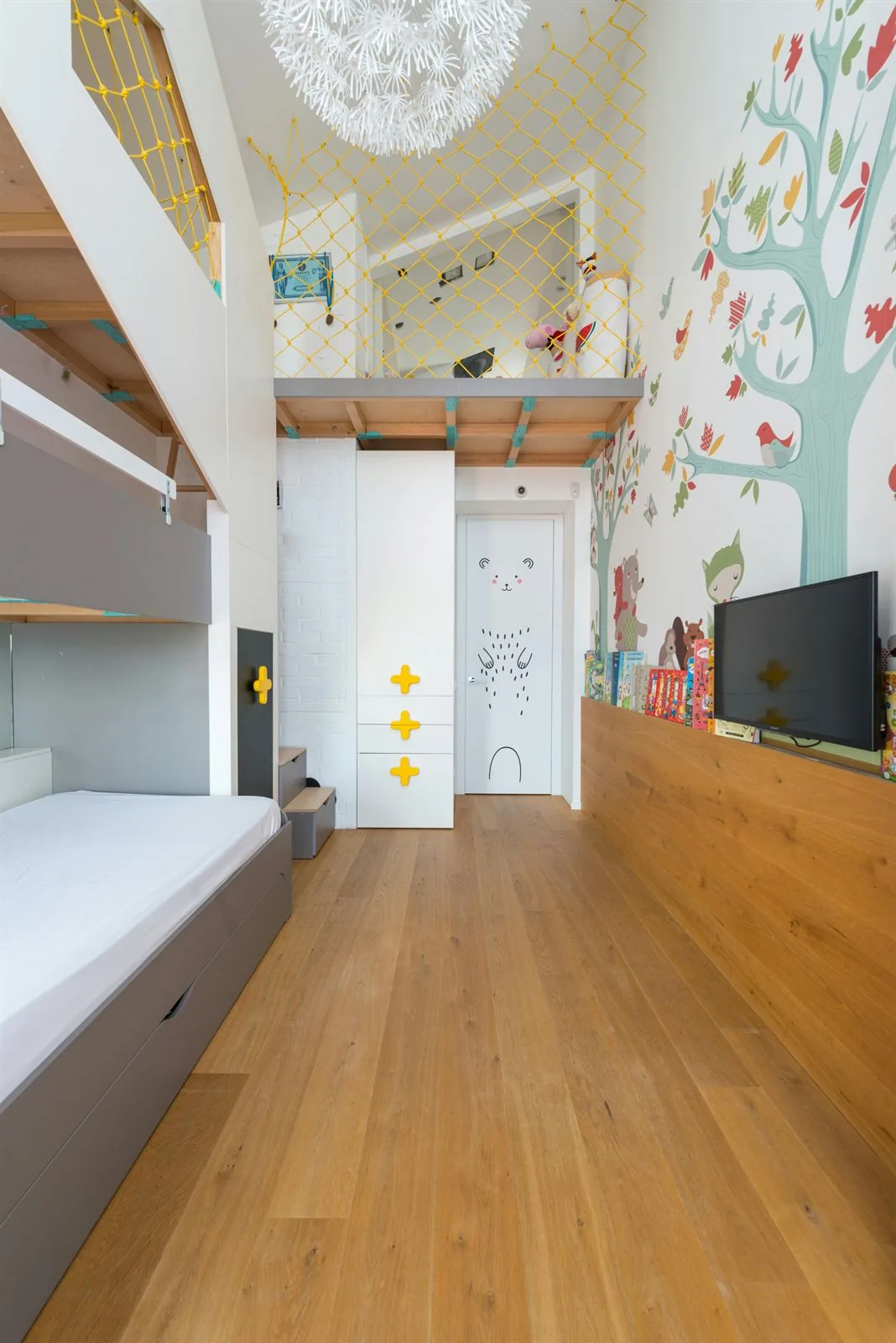 Kids bedroom with loft bed, mural wall, storage, and one long clear path