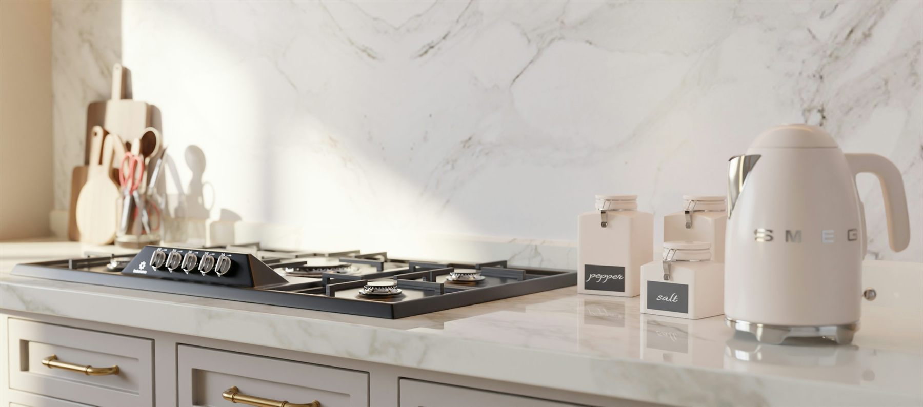 Marble kitchen counter with pale cabinetry, brass handles, stove, and a white kettle
