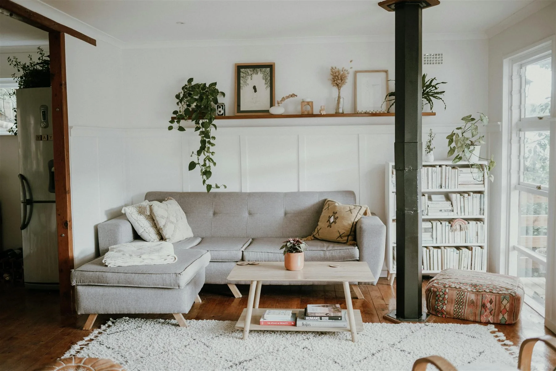 Airy living room with pale upholstery, wood coffee table, and a calm light palette