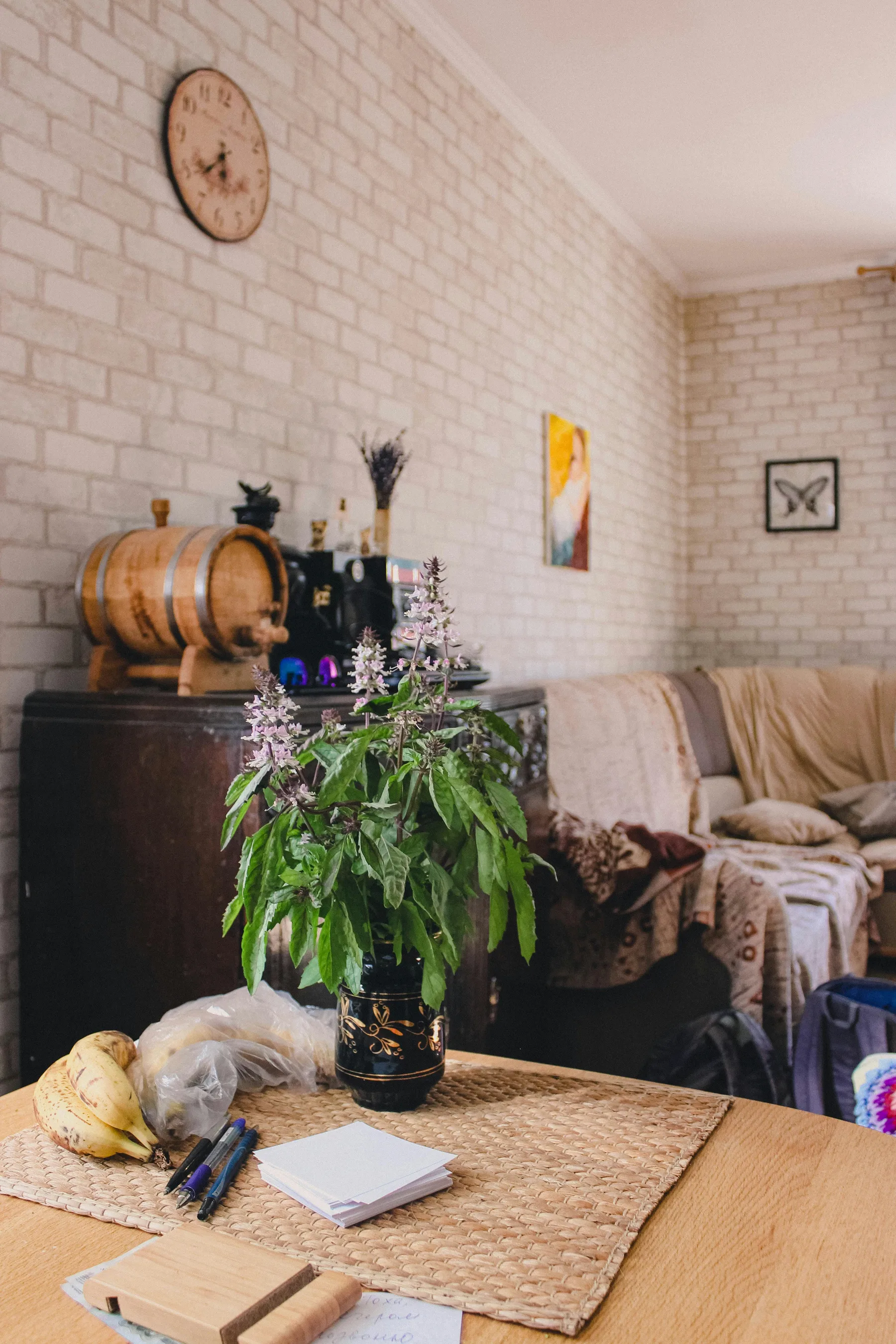 Tall living room with edited shelves, warm neutrals, and more controlled decorative layering