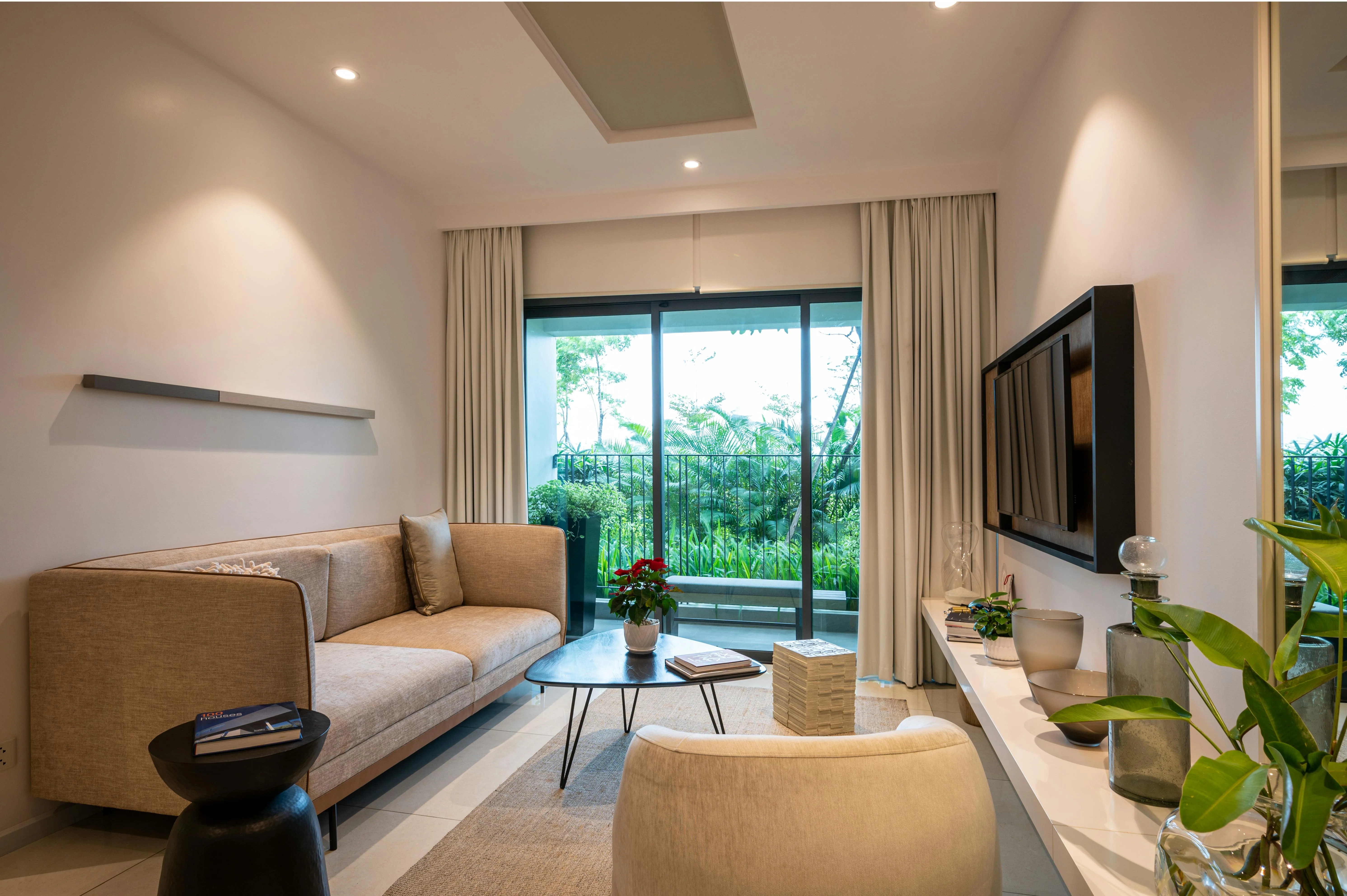 Living room with a television wall, seating group, and multiple visual anchors competing for attention