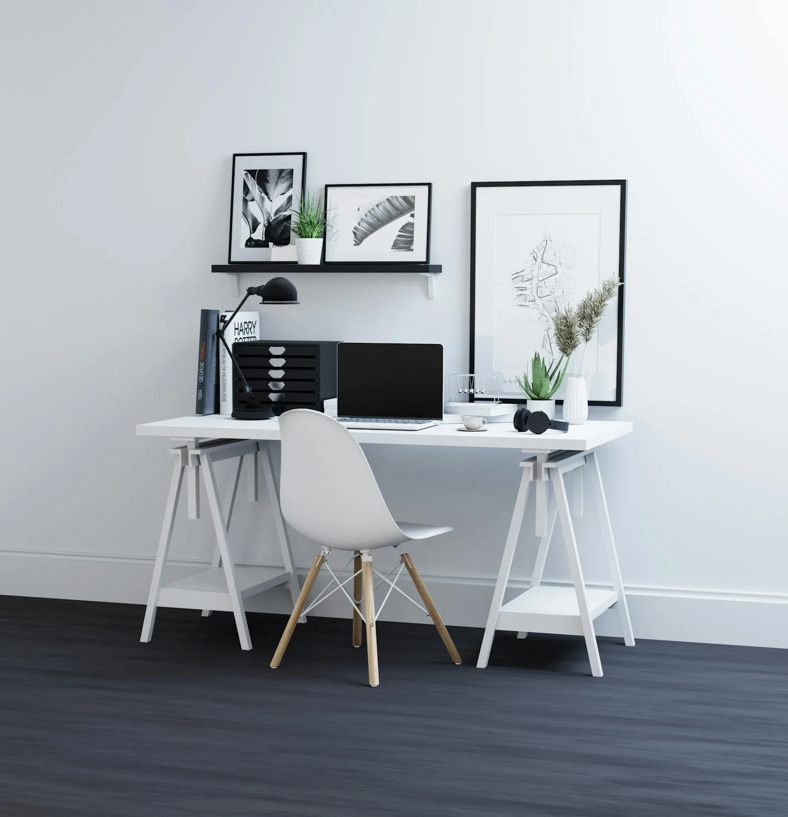 White office with black accents, framed art, and a cleaner desk setup