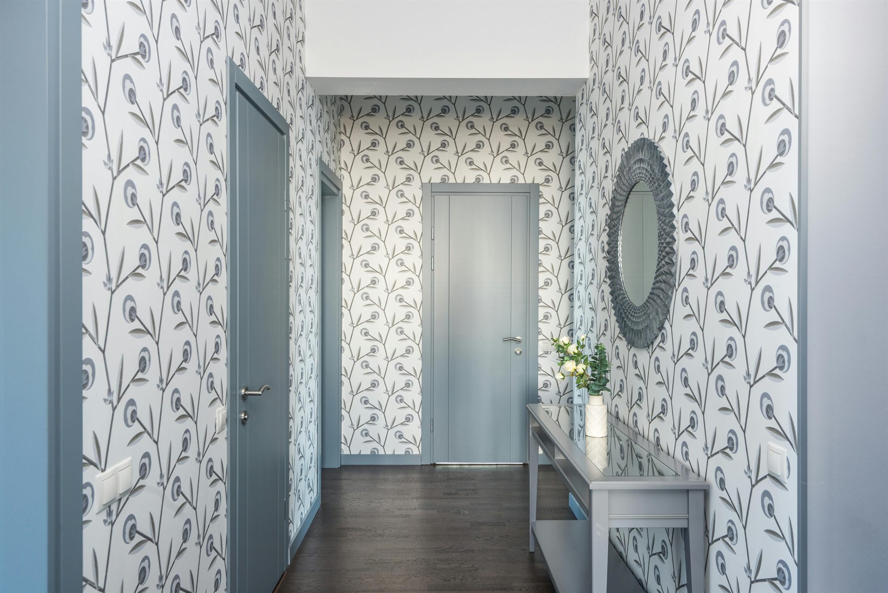 Hallway with a decorative wall mirror above a narrow console table