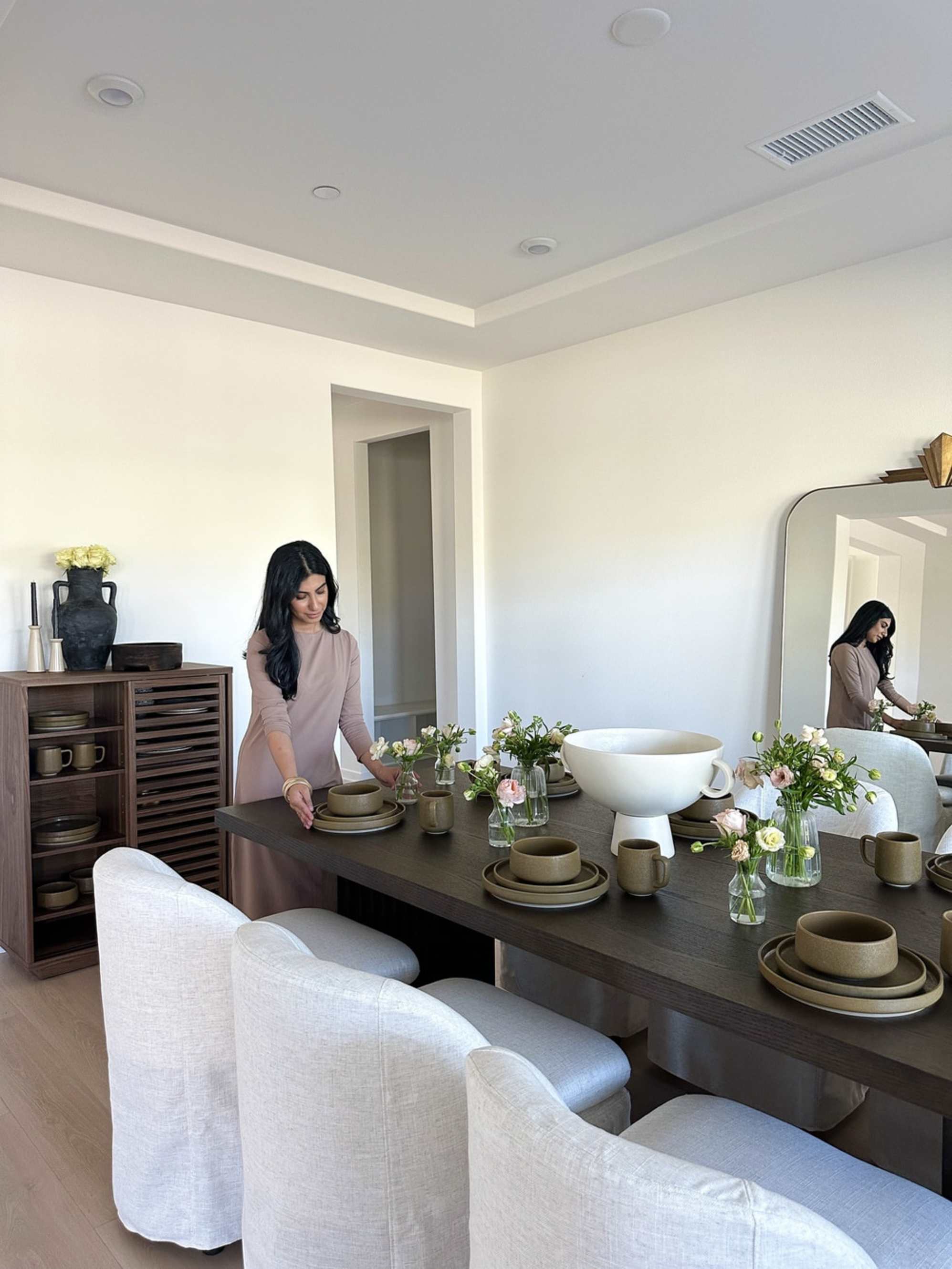 Dining table with flowers, bowls, and a more abundant maintained feel