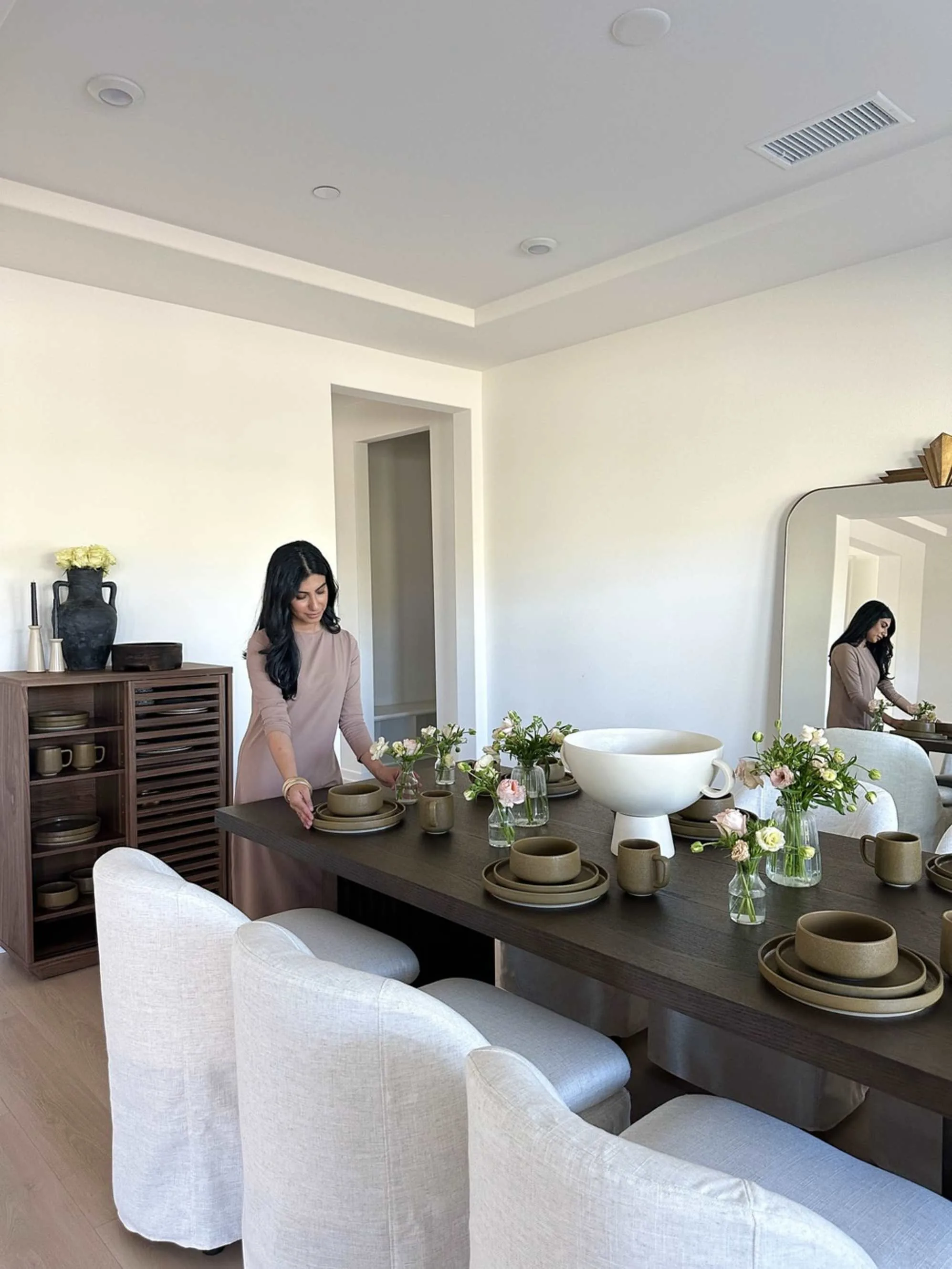 Dining table with flowers, bowls, and a more abundant maintained feel