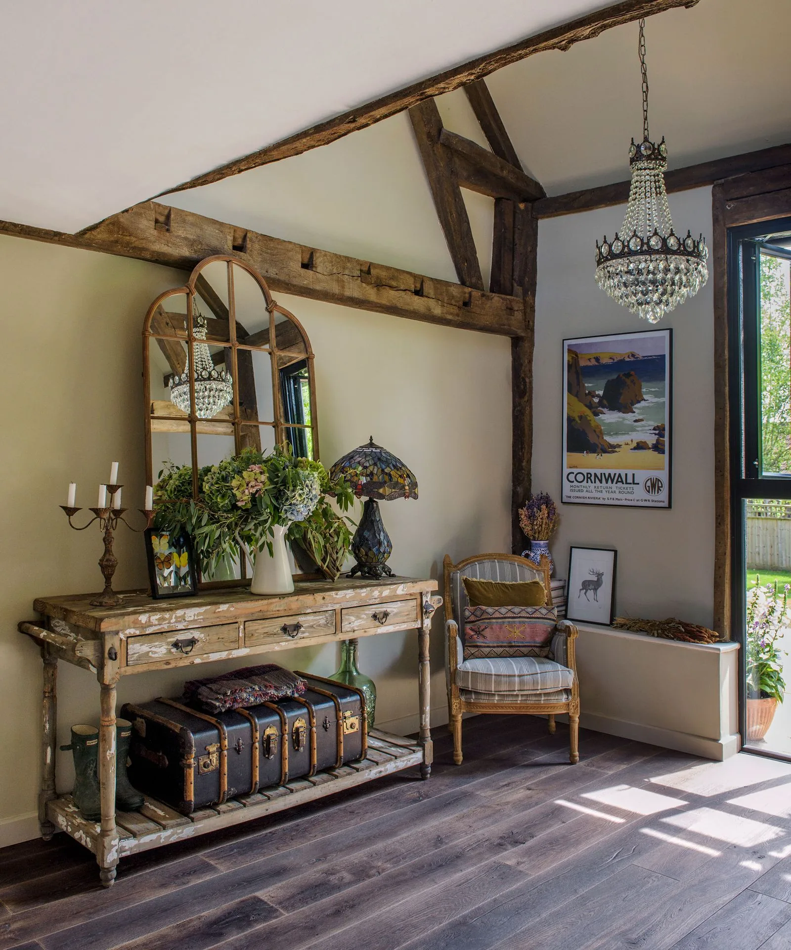 Entry console with flowers, lamp, mirror, and a more cared-for welcoming threshold