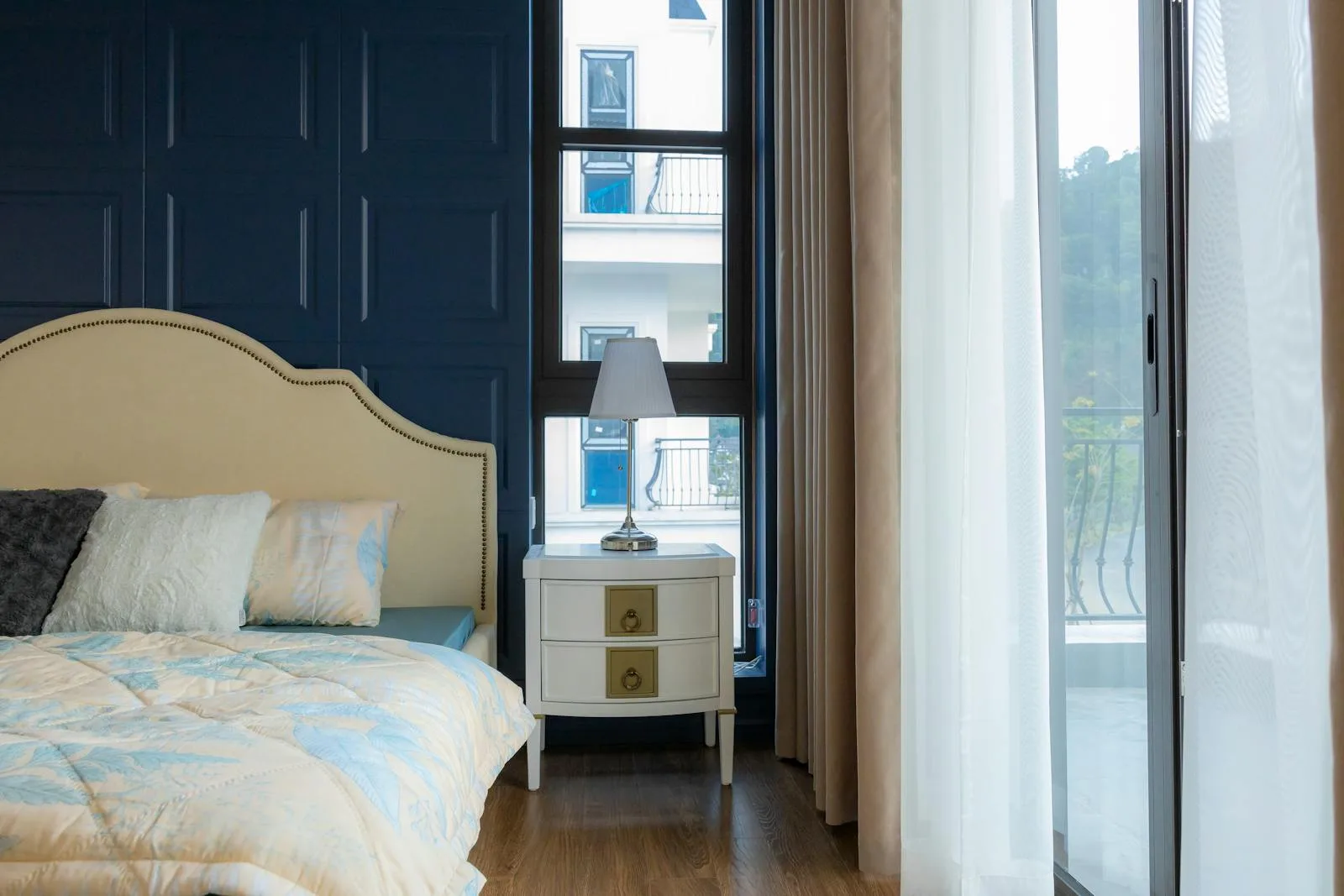 Bright bedroom with made bed, natural light, and a calmer settled feeling