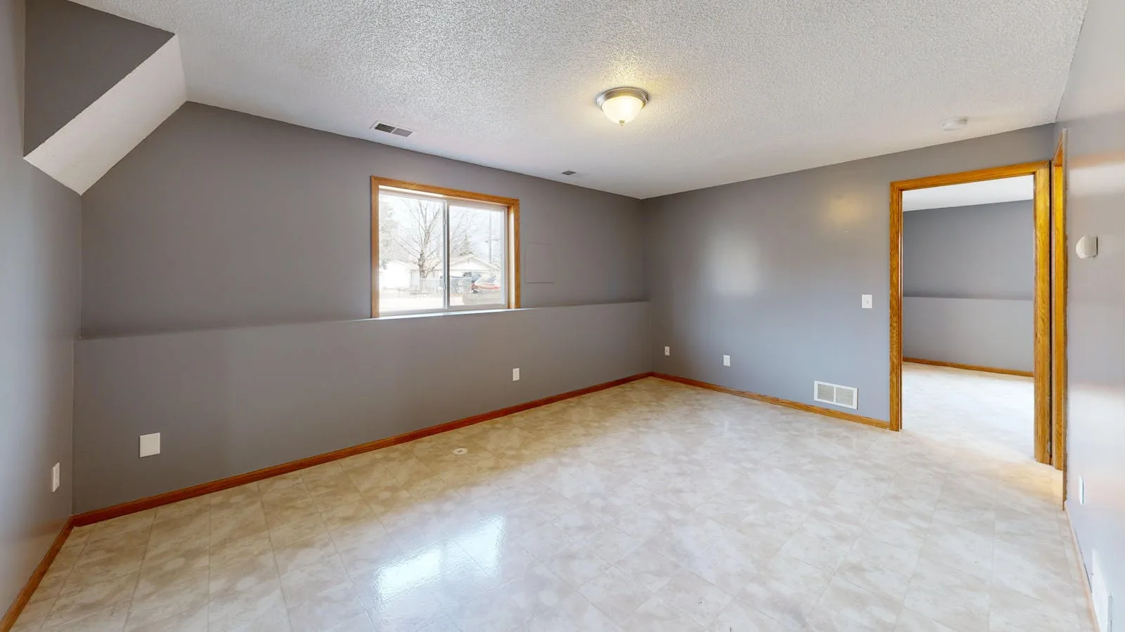 Bright empty room with window light and open floor area ready for a calmer setup
