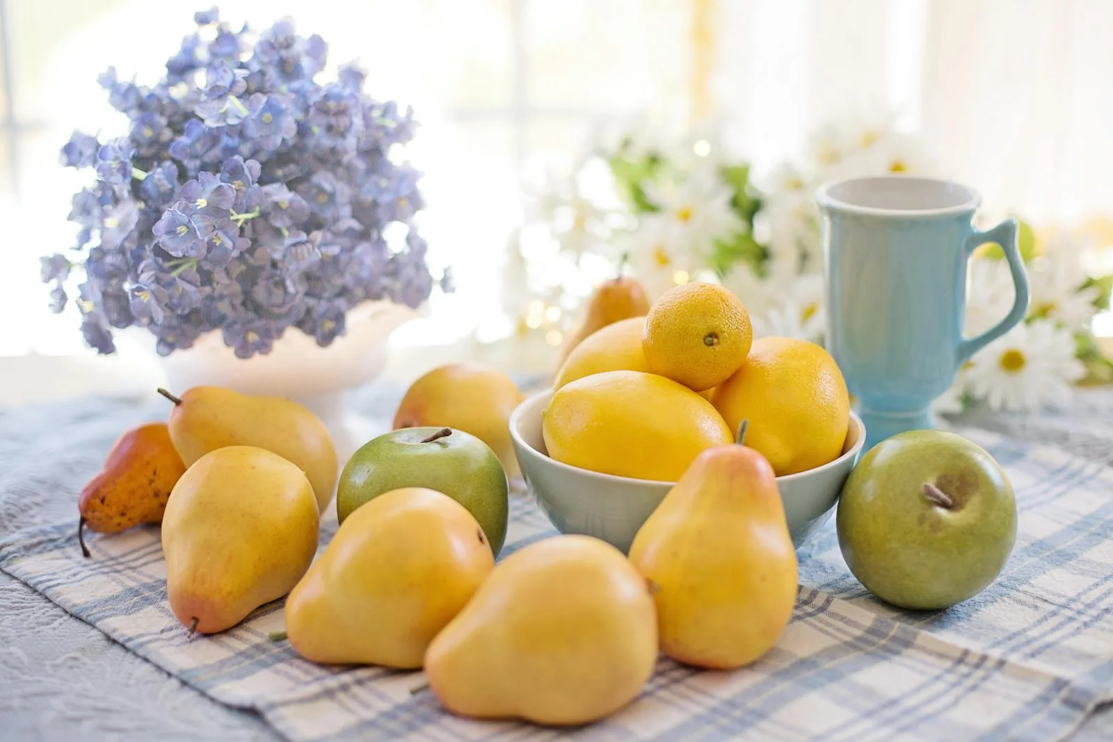 Fresh fruit and flowers arranged on a table as a simple nourishing cue in a new home