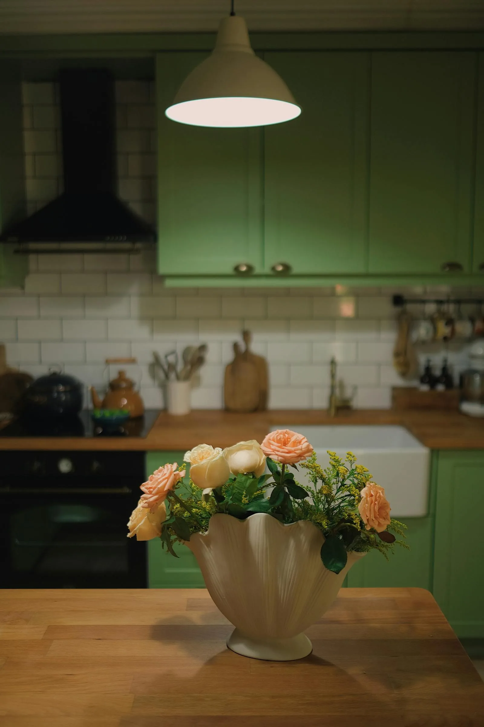 Kitchen counter with flowers, warm cabinets, and a more cared-for move-in feel