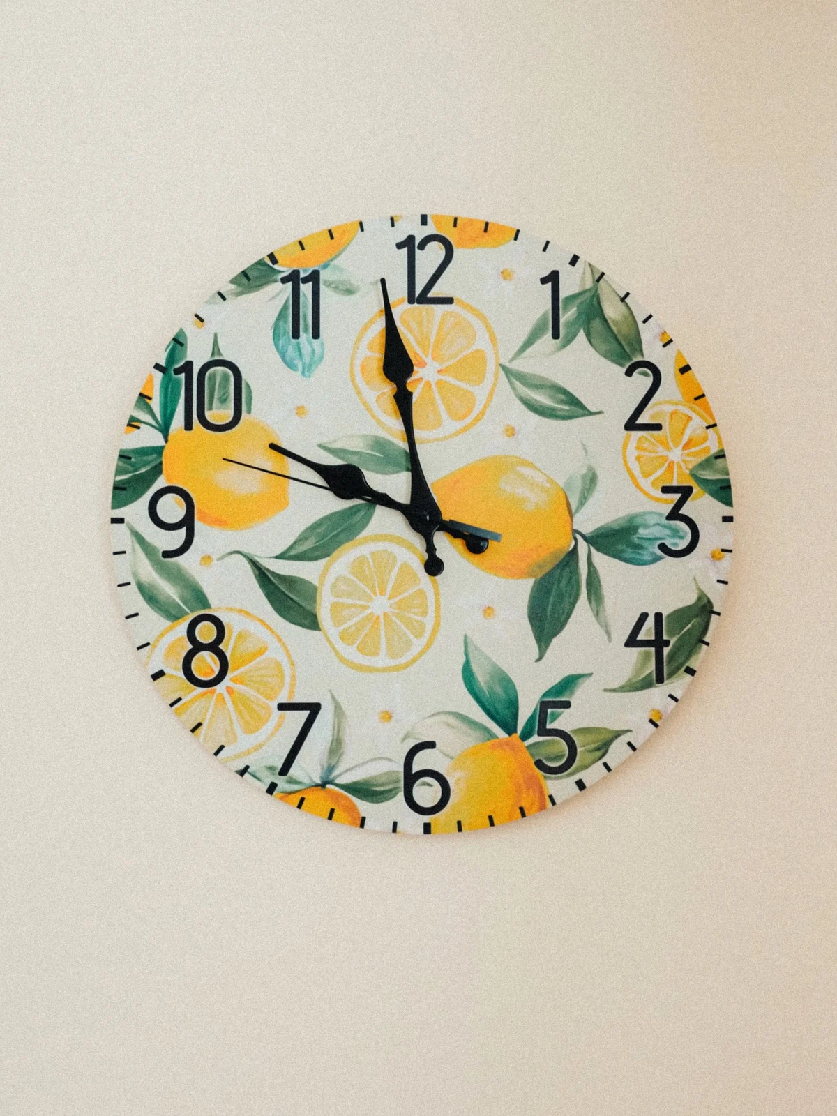 Lemon-patterned wall clock with large black numerals and dark hands