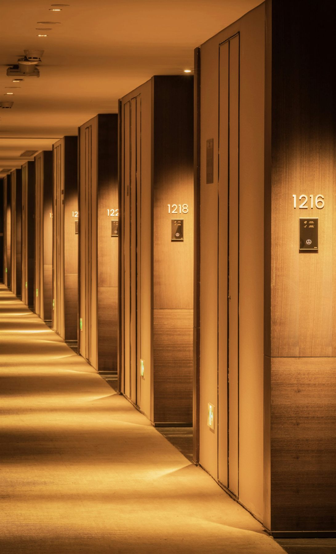 Hallway with numbered apartment or hotel-style doors in a clean row