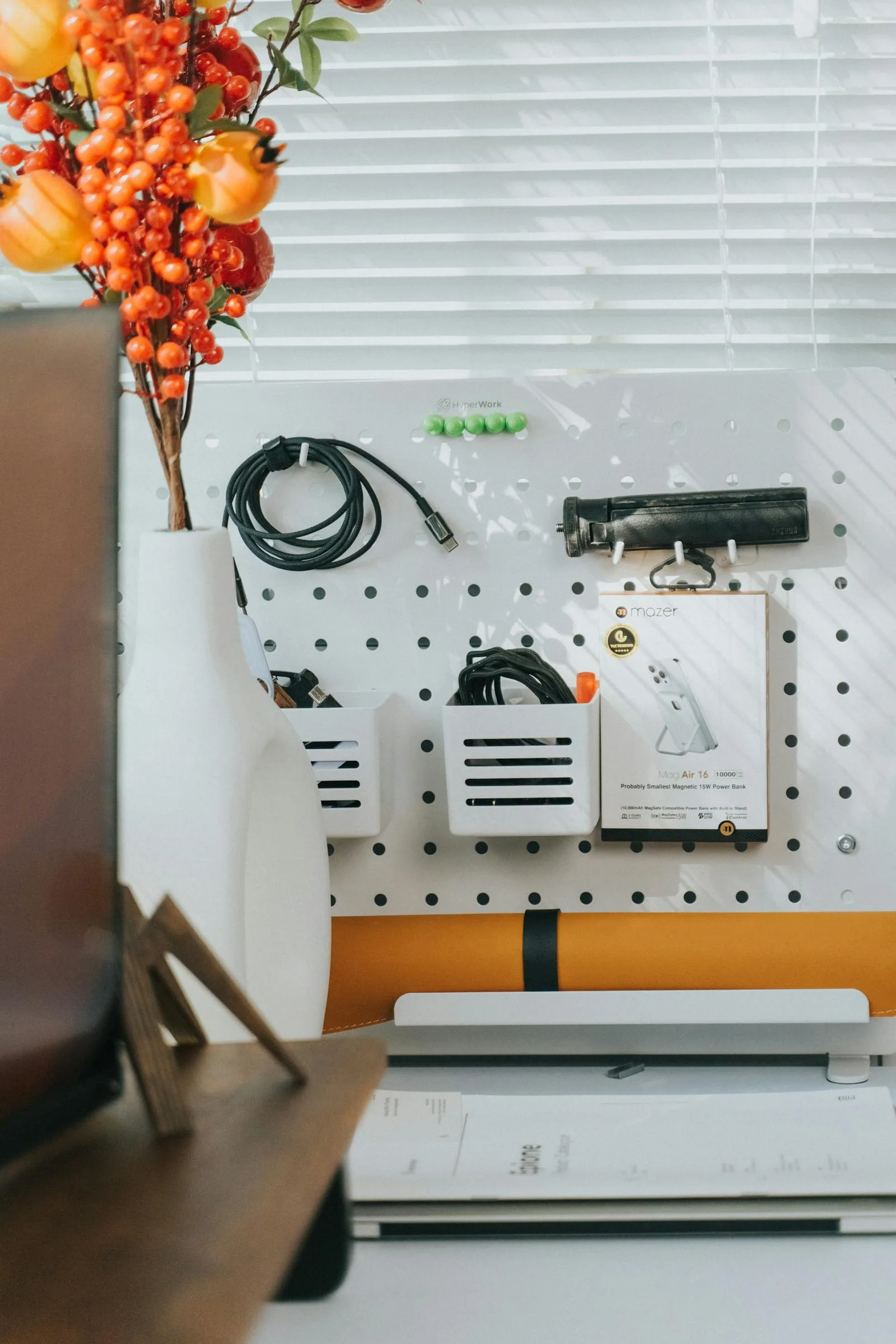 Pegboard office wall with organized accessories and supplies
