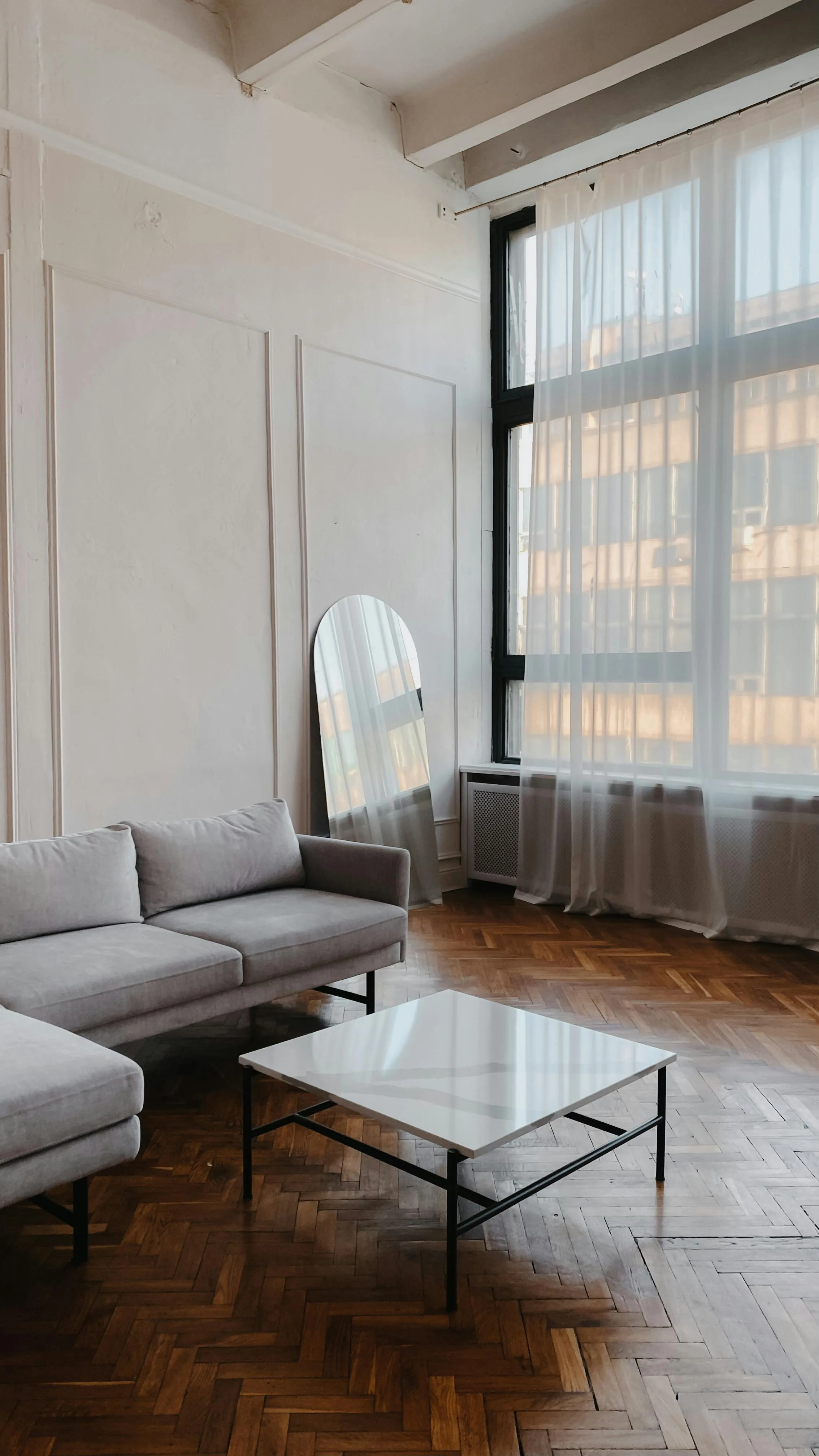 Sunlit neutral room with filtered daylight, pale walls, and a softer calmer mood