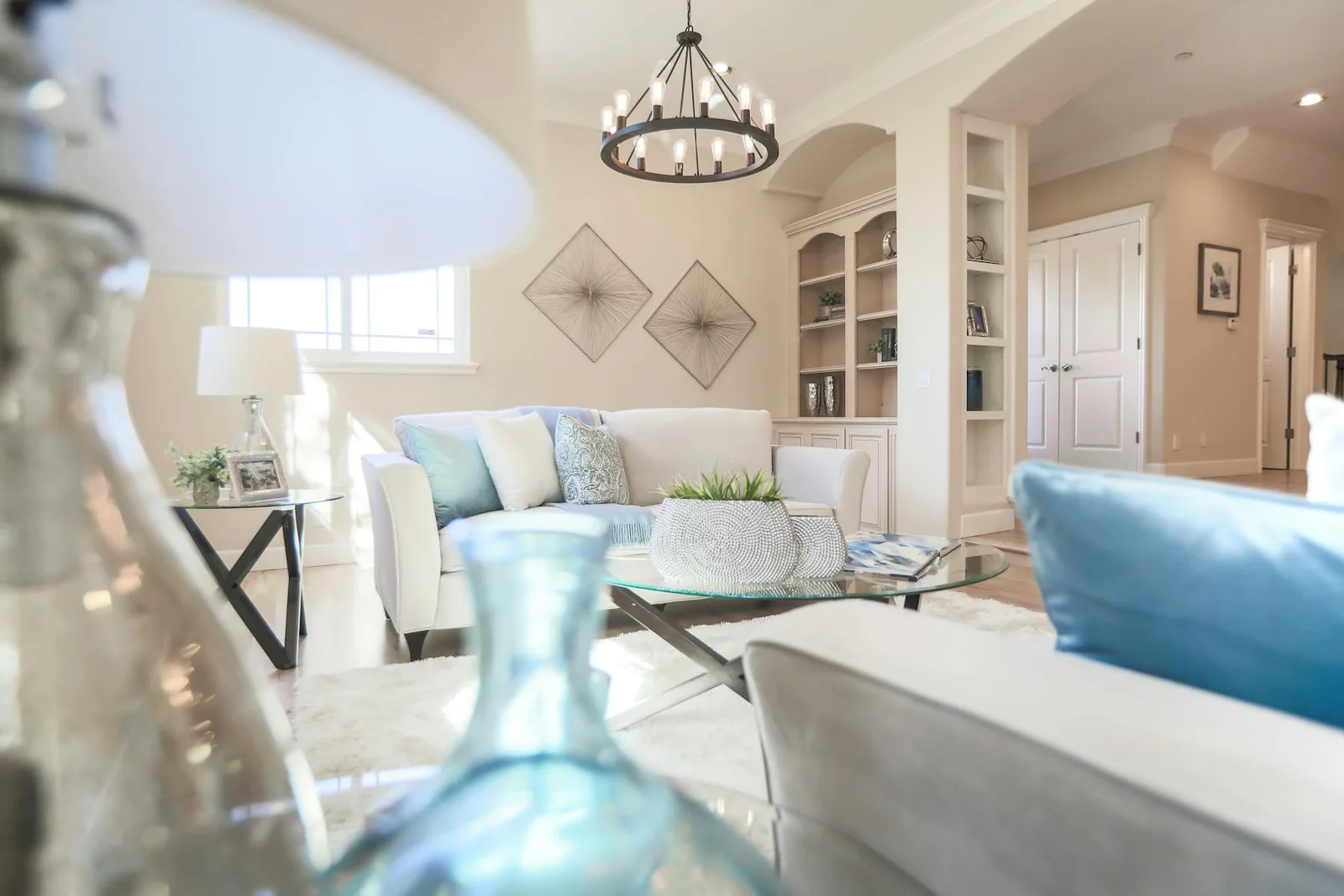 Light living room with blue accents, pale upholstery, and soft daylight