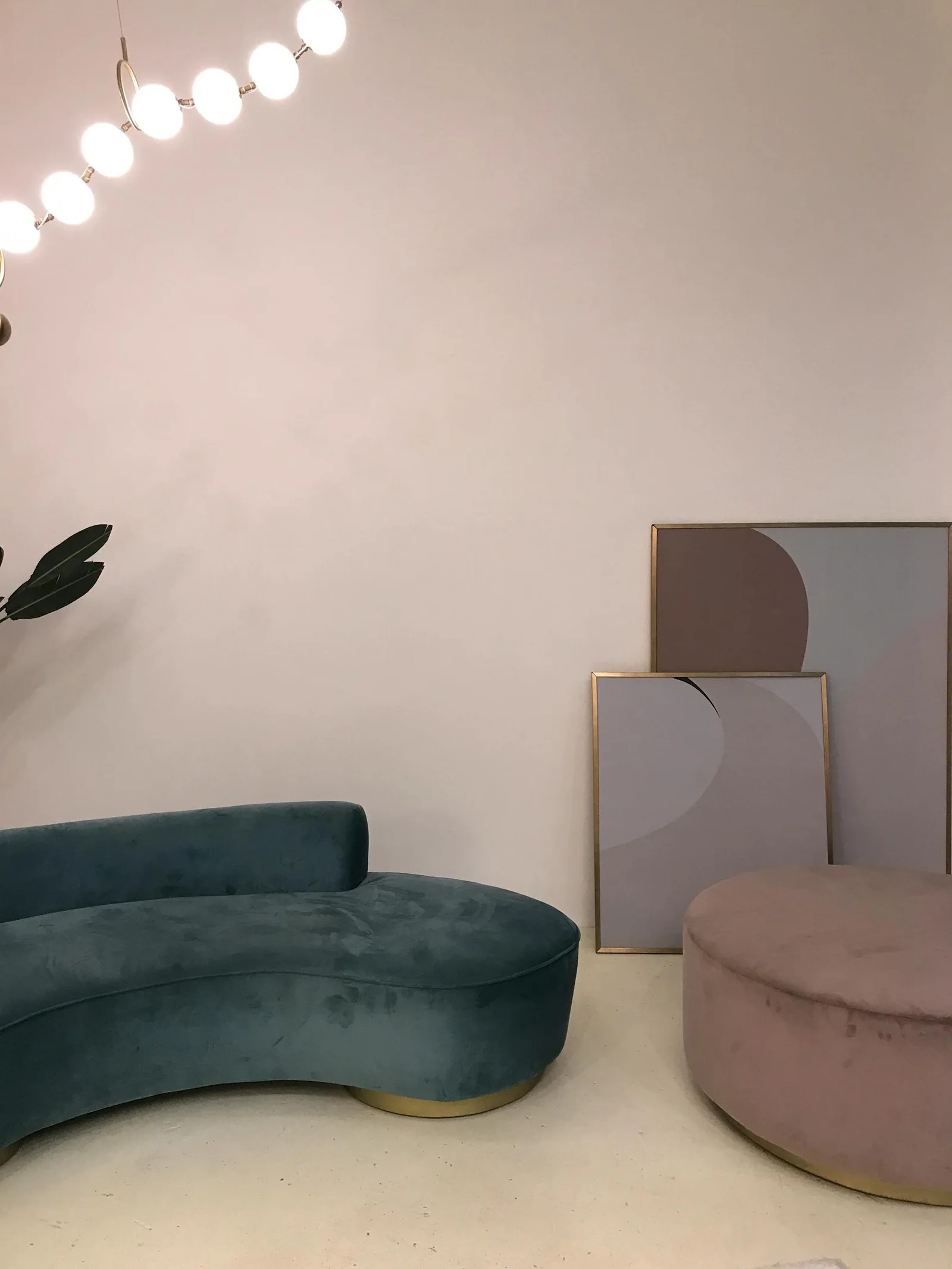 Minimal living room corner with navy sofa, soft wall art, and quiet neutral background