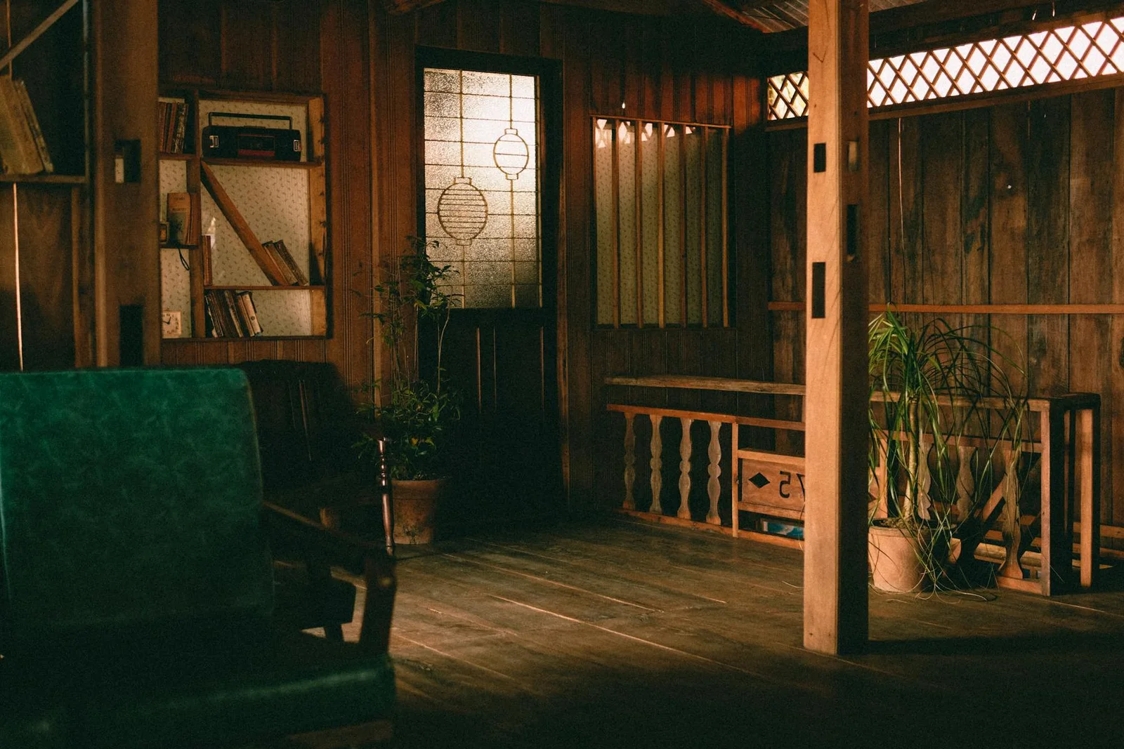 Warm wood interior with dark green seating and layered natural materials